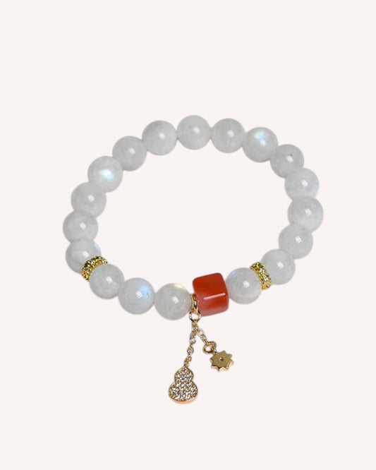 Side angle of Moonstone and Red Coral bracelet with lucky charm accents for emotional healing and clarity