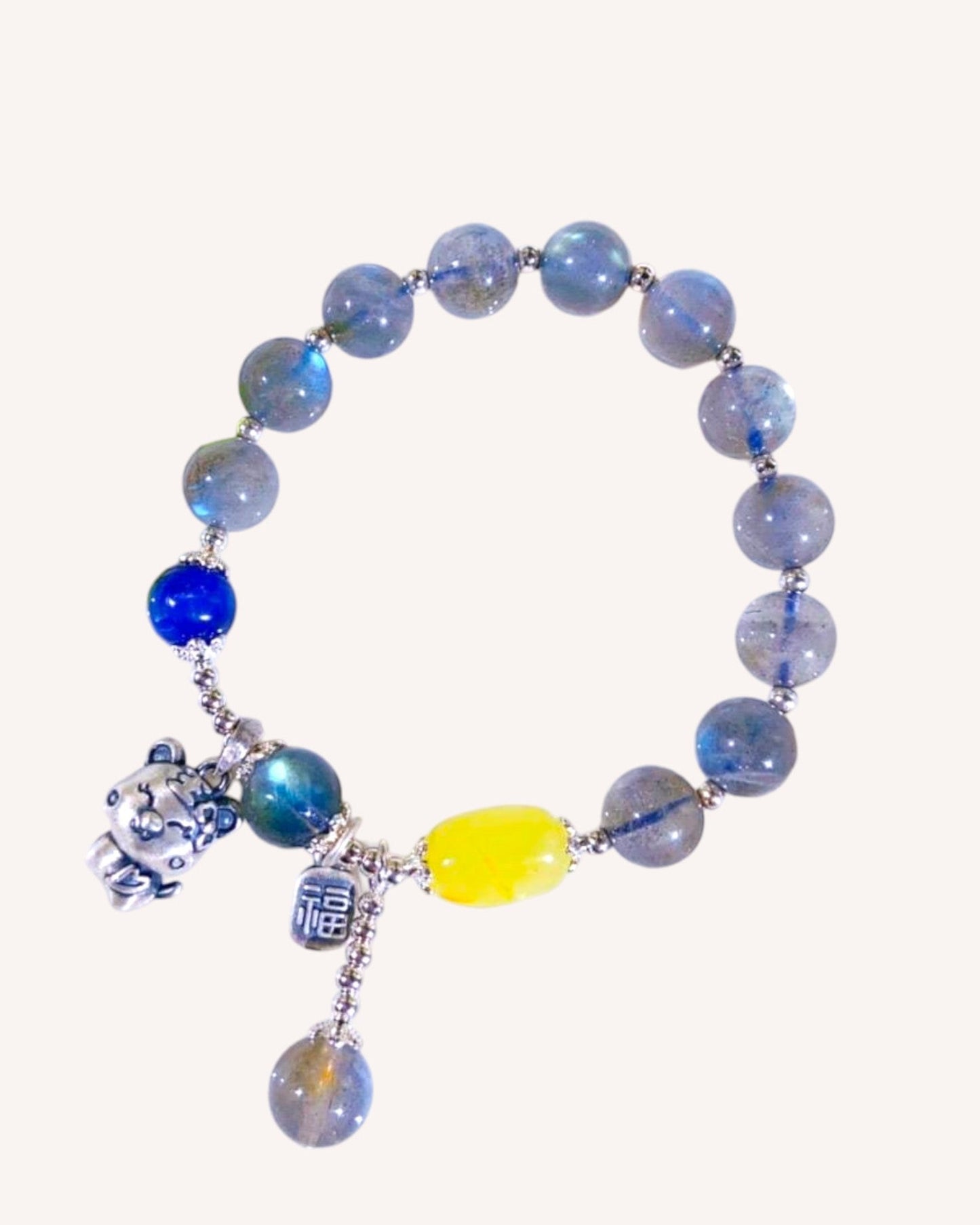 Kyanite and Amber gemstone bracelet with Blue Moonstone and fine silver, designed for intuition, protection, and communication clarity.