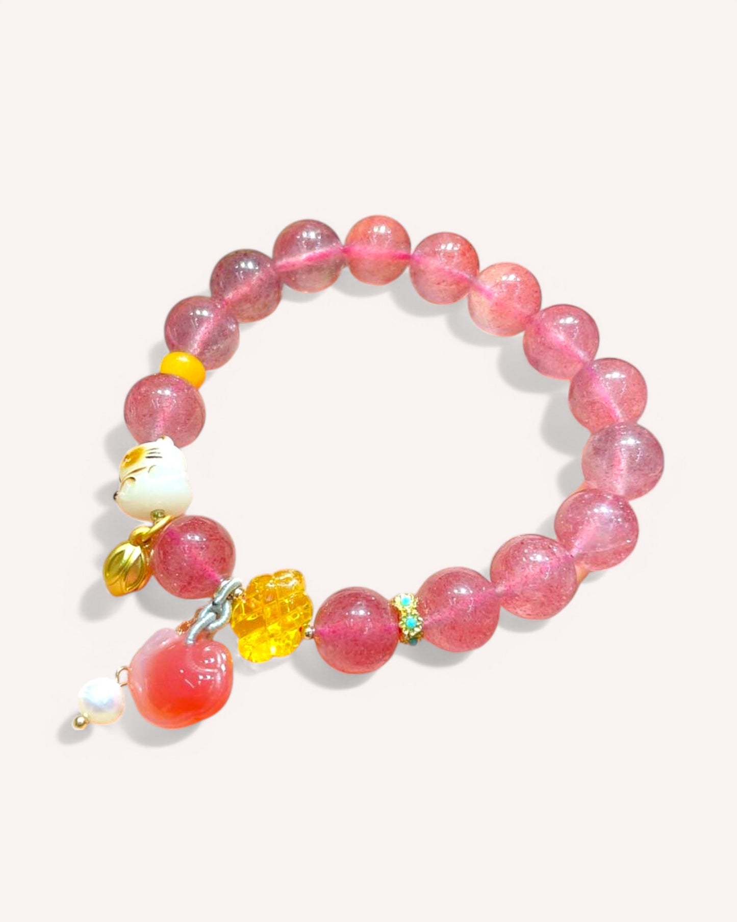 Strawberry Quartz and Amber bracelet for love and confidence, displayed on white background