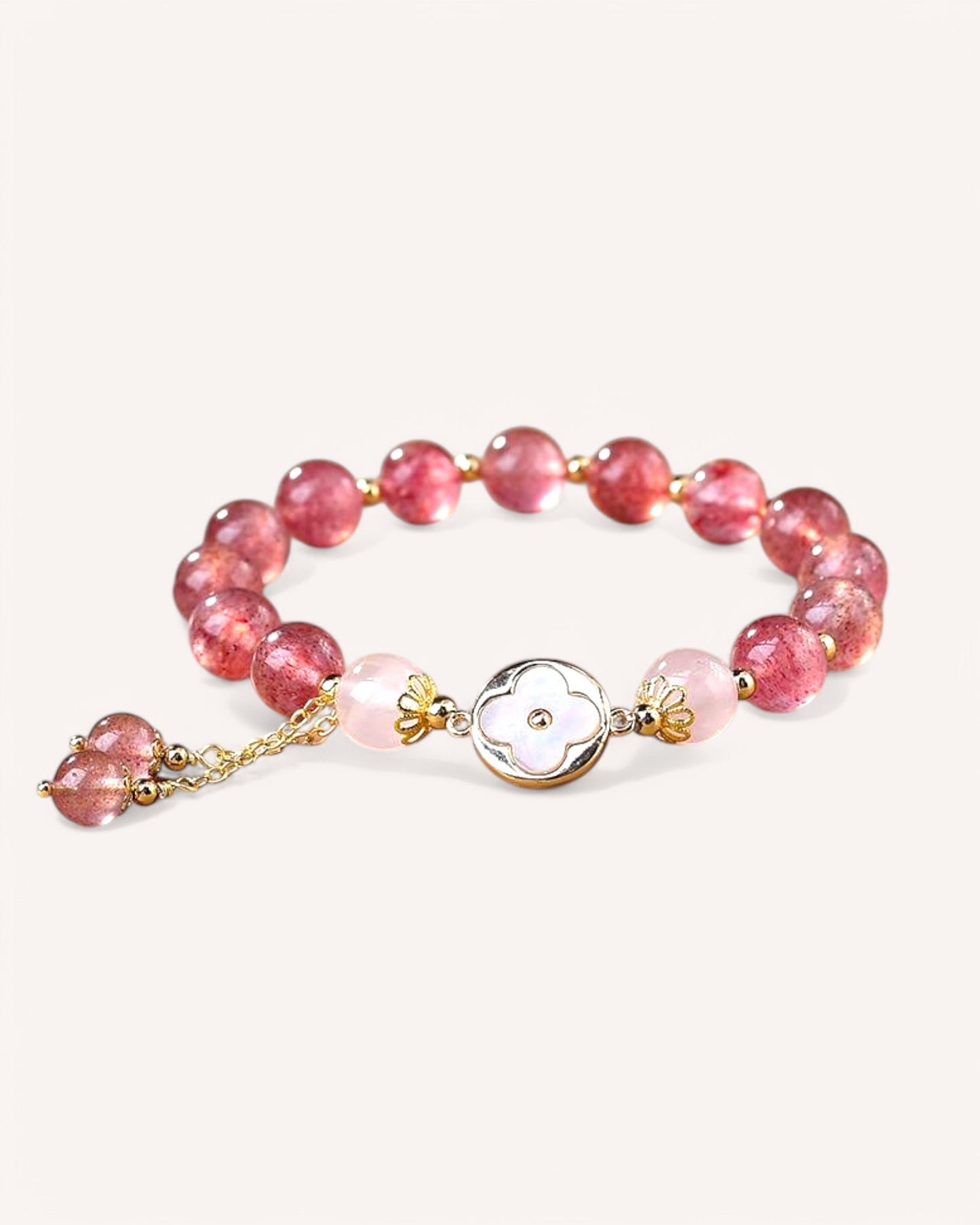 Side-angle shot of Strawberry Quartz crystal bracelet promoting love, self-worth, and emotional wellness