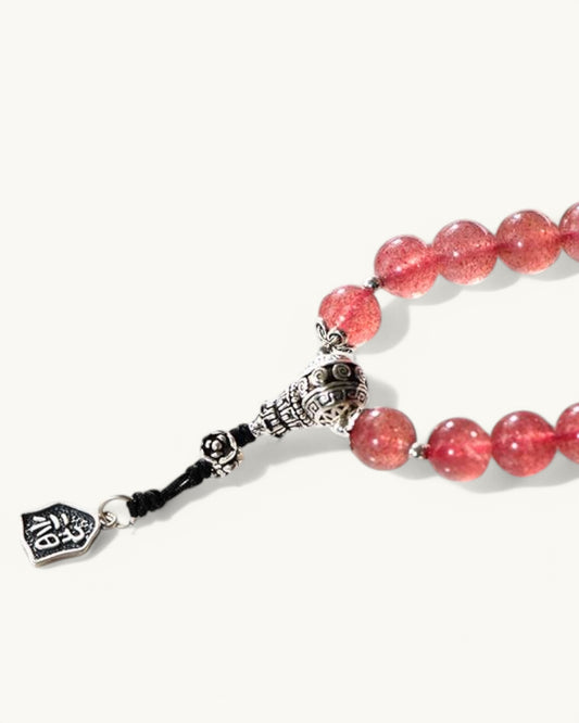 Side view of Dragon Zodiac Strawberry Quartz bracelet showing silver charm details