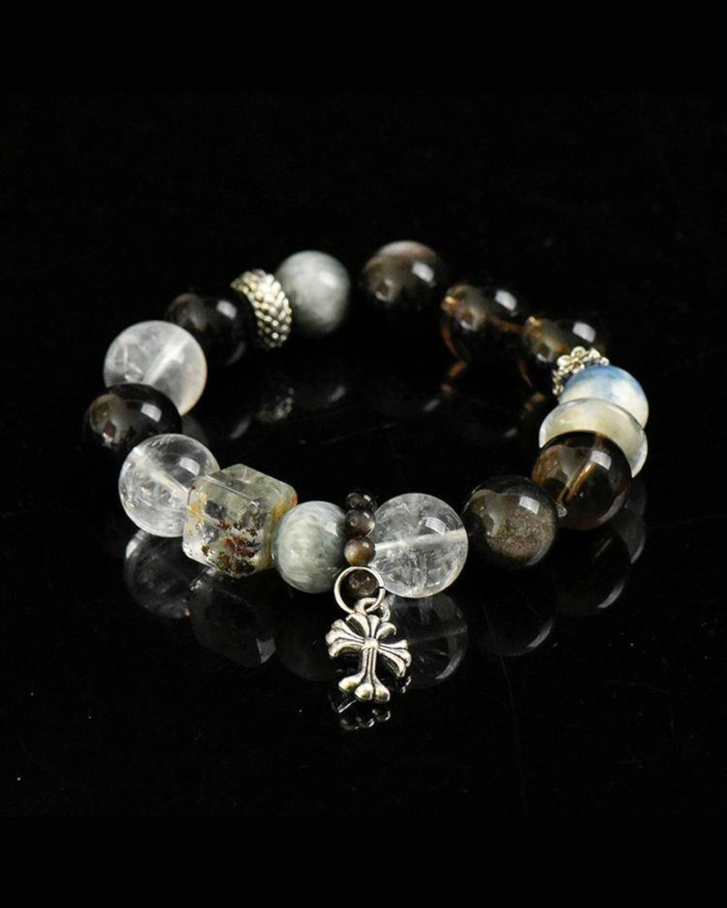 Strength & Focus Bracelet photographed on dark background, featuring Smoky Quartz, Hawk’s Eye, Phantom Quartz, and Obsidian for protection and resilience.