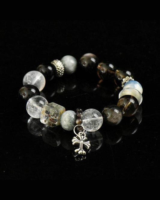 Strength & Focus Bracelet photographed on dark background, featuring Smoky Quartz, Hawk’s Eye, Phantom Quartz, and Obsidian for protection and resilience.