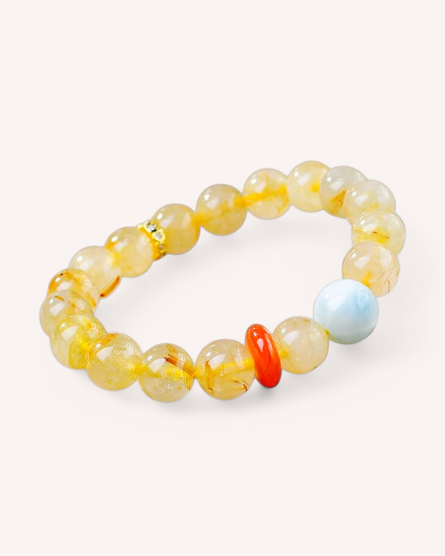 Side view of gemstone bracelet featuring Larimar and Rutilated Quartz with red agate for clarity, prosperity, and calm energy.