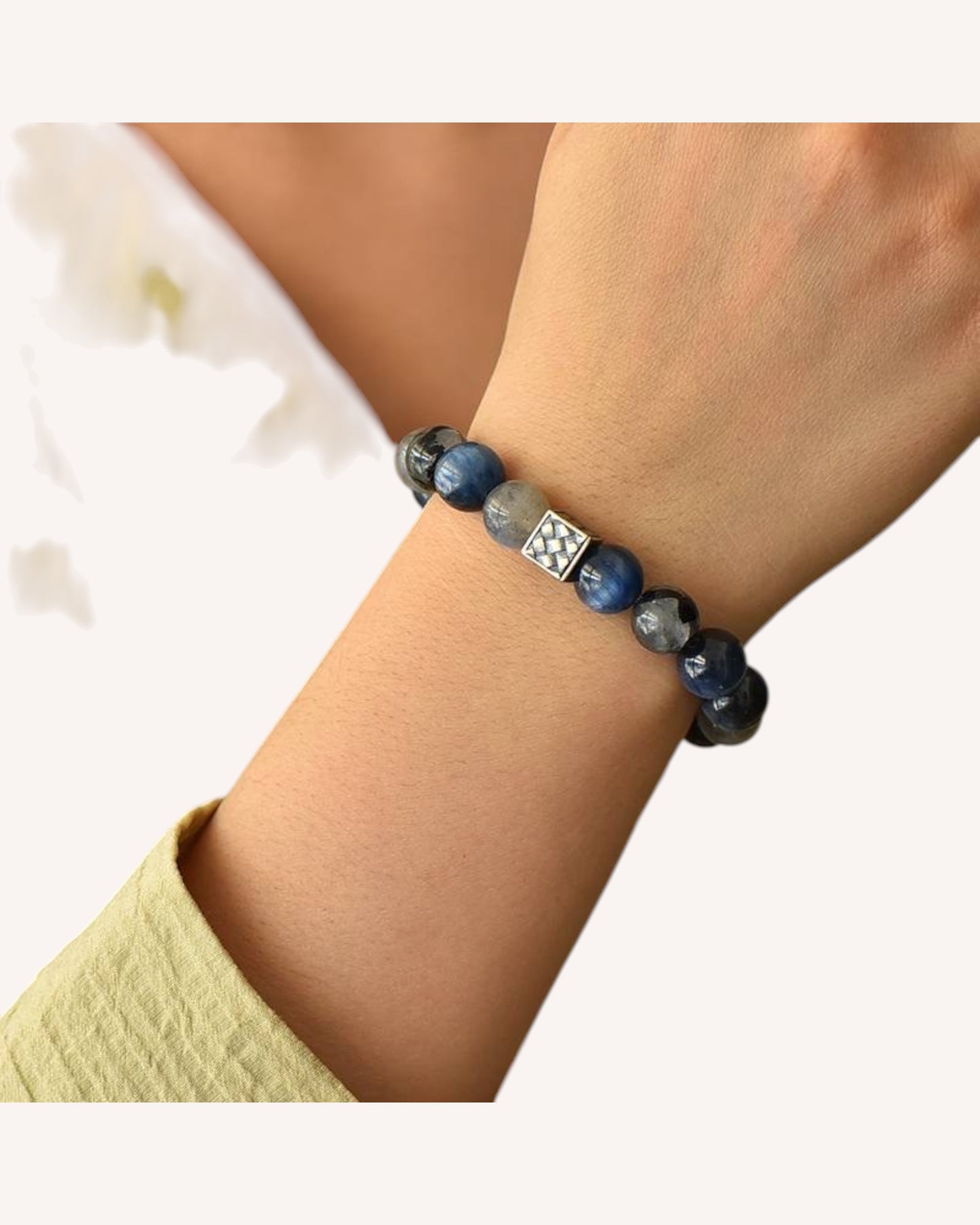 Person wearing Blue Rutile Quartz and Moonstone bracelet to enhance emotional balance and inner calm