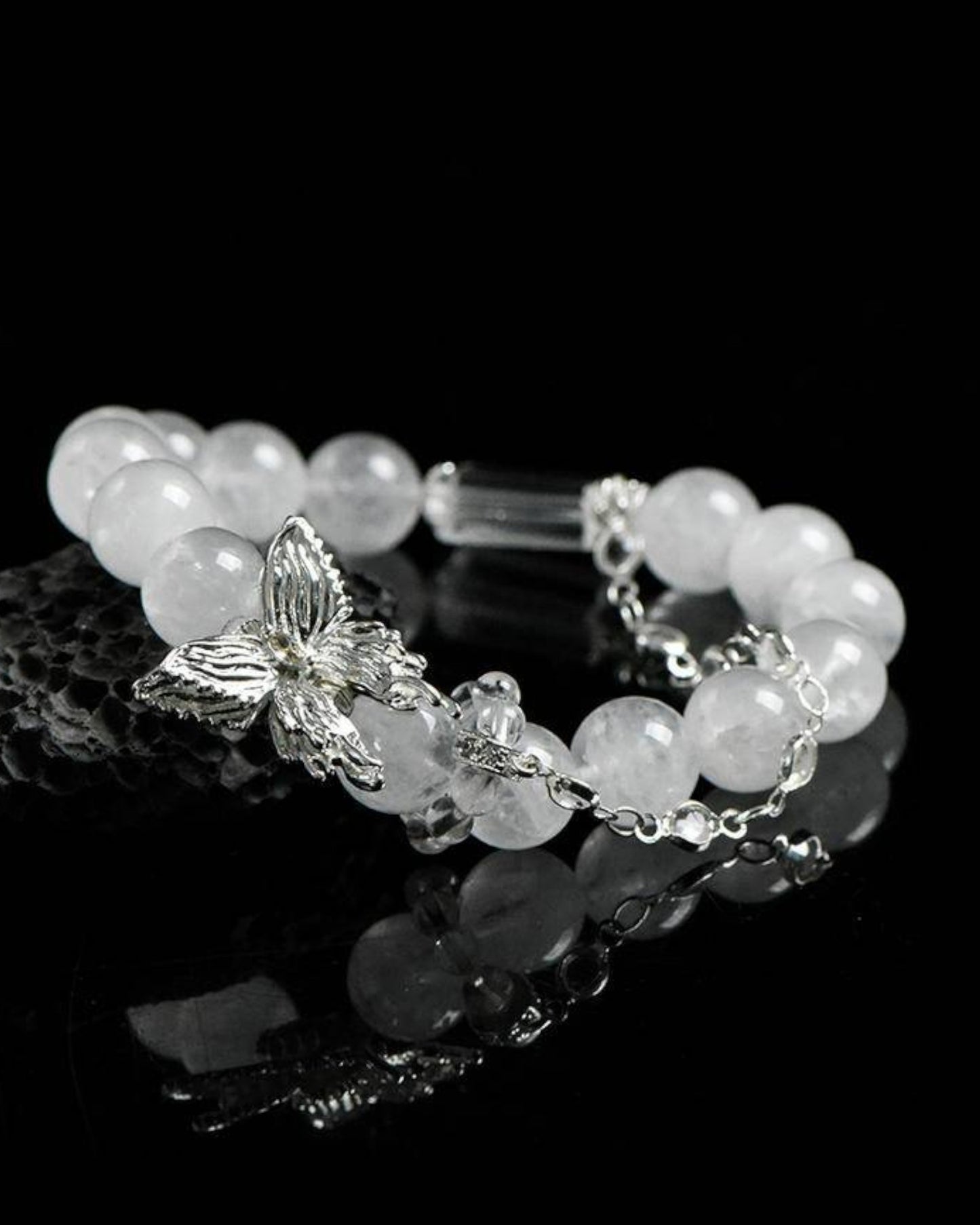 Close-up of White Phantom Quartz bracelet with butterfly charm, symbolizing healing, peace, and transformation