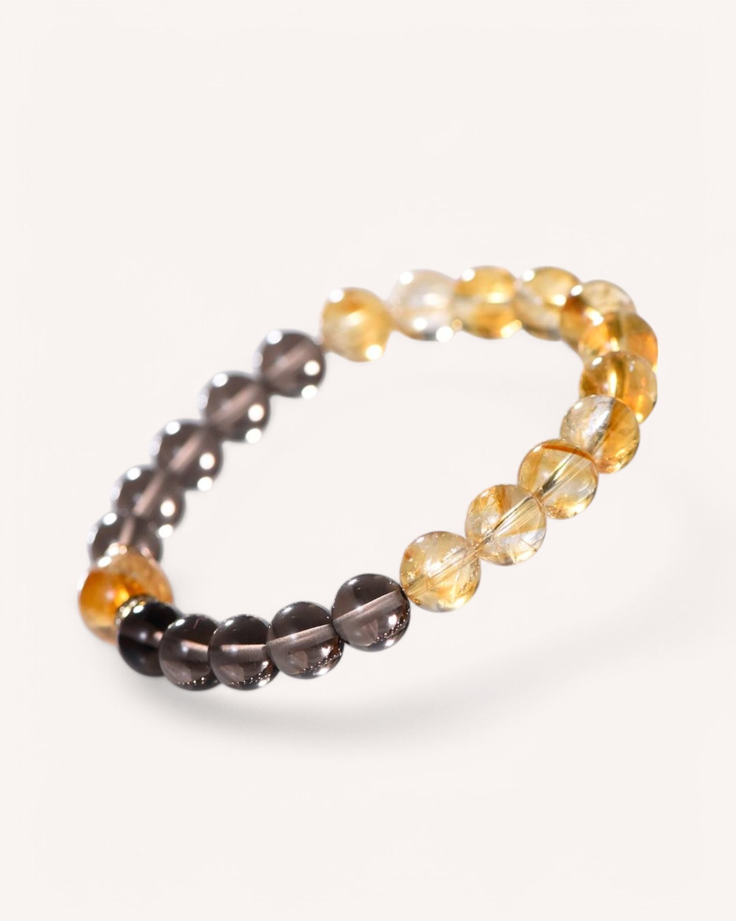 Crystal bracelet featuring Yellow Azeztulite and Smoky Quartz to attract wealth and emotional balance, angled view