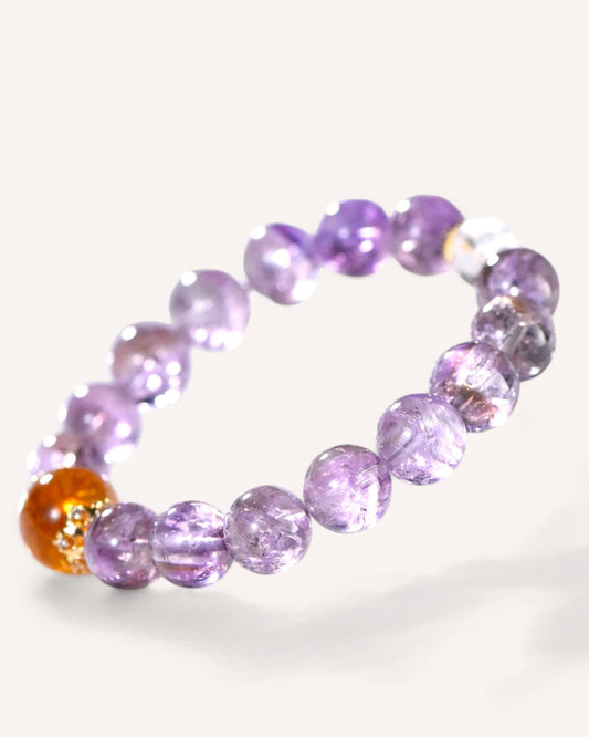 A close-up of the Amethyst & Yellow Azeztulite Fortune Energy Bracelet, featuring faceted amethyst and yellow azeztulite beads designed to attract prosperity and enhance spiritual clarity.