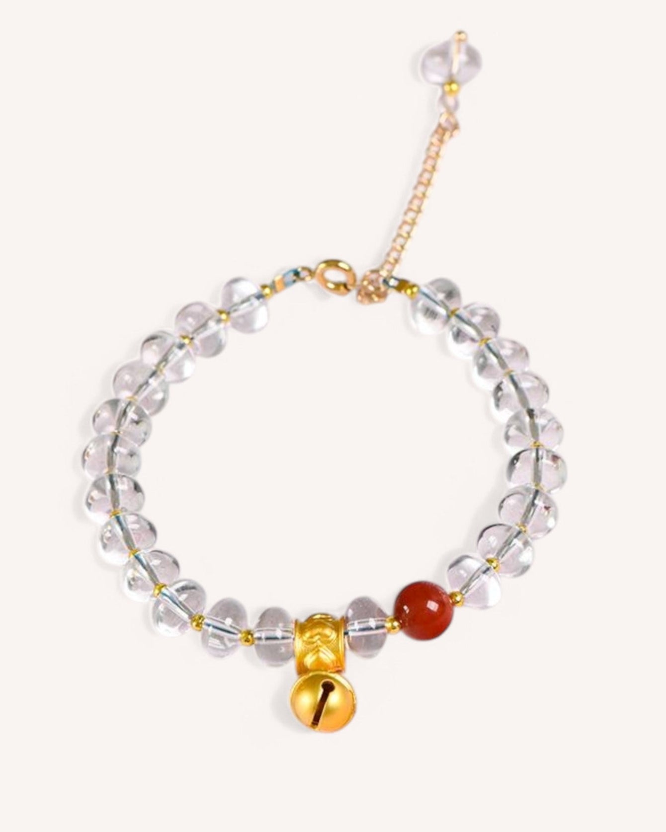 A stunning white quartz and red coral bracelet with a gold bell charm, symbolizing energy balance, good fortune, and emotional stability.