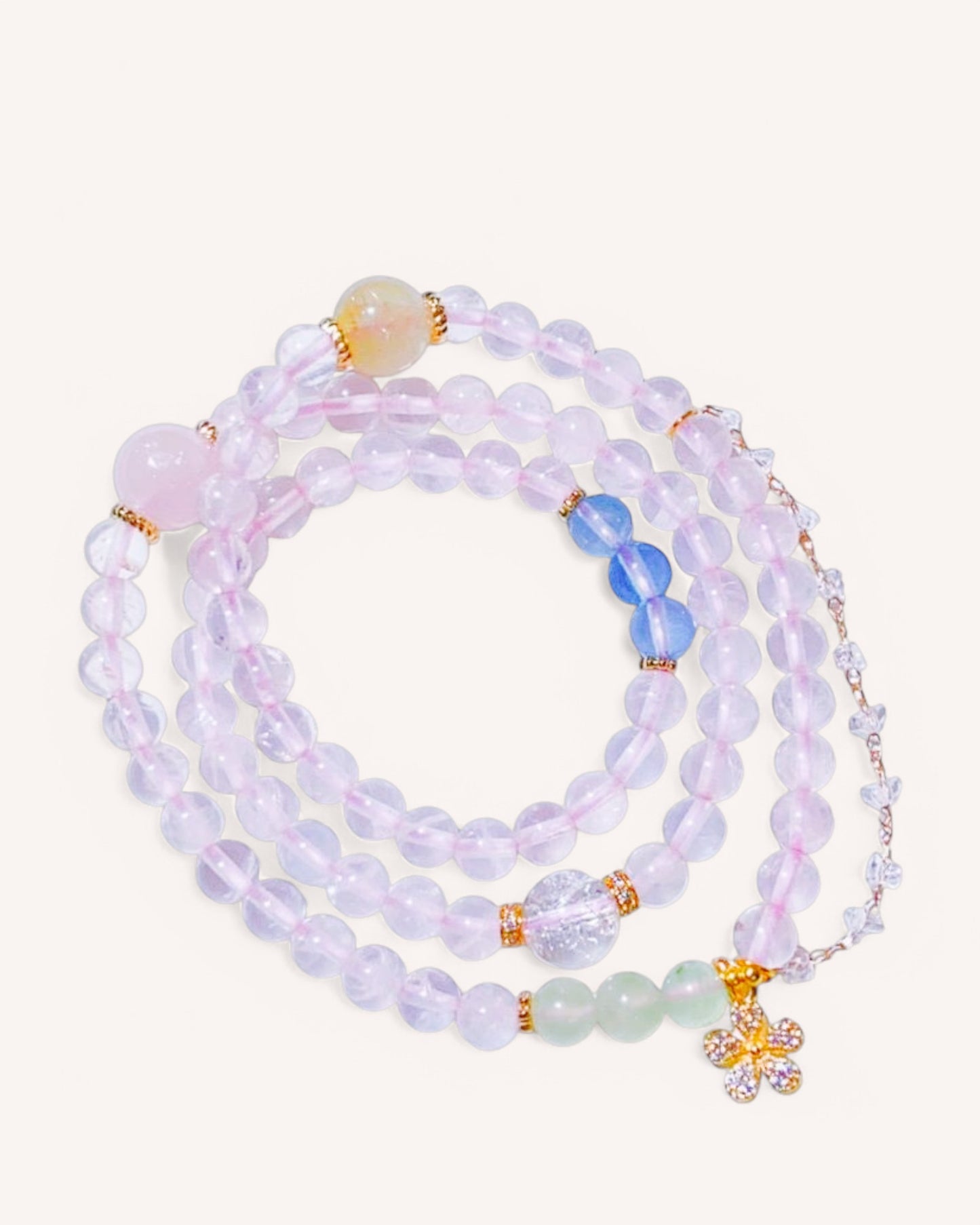 A multi-layered Rose Quartz bracelet with Golden Rutilated Quartz, Aquamarine, and Prehnite, designed for love, emotional healing, and energy balance.