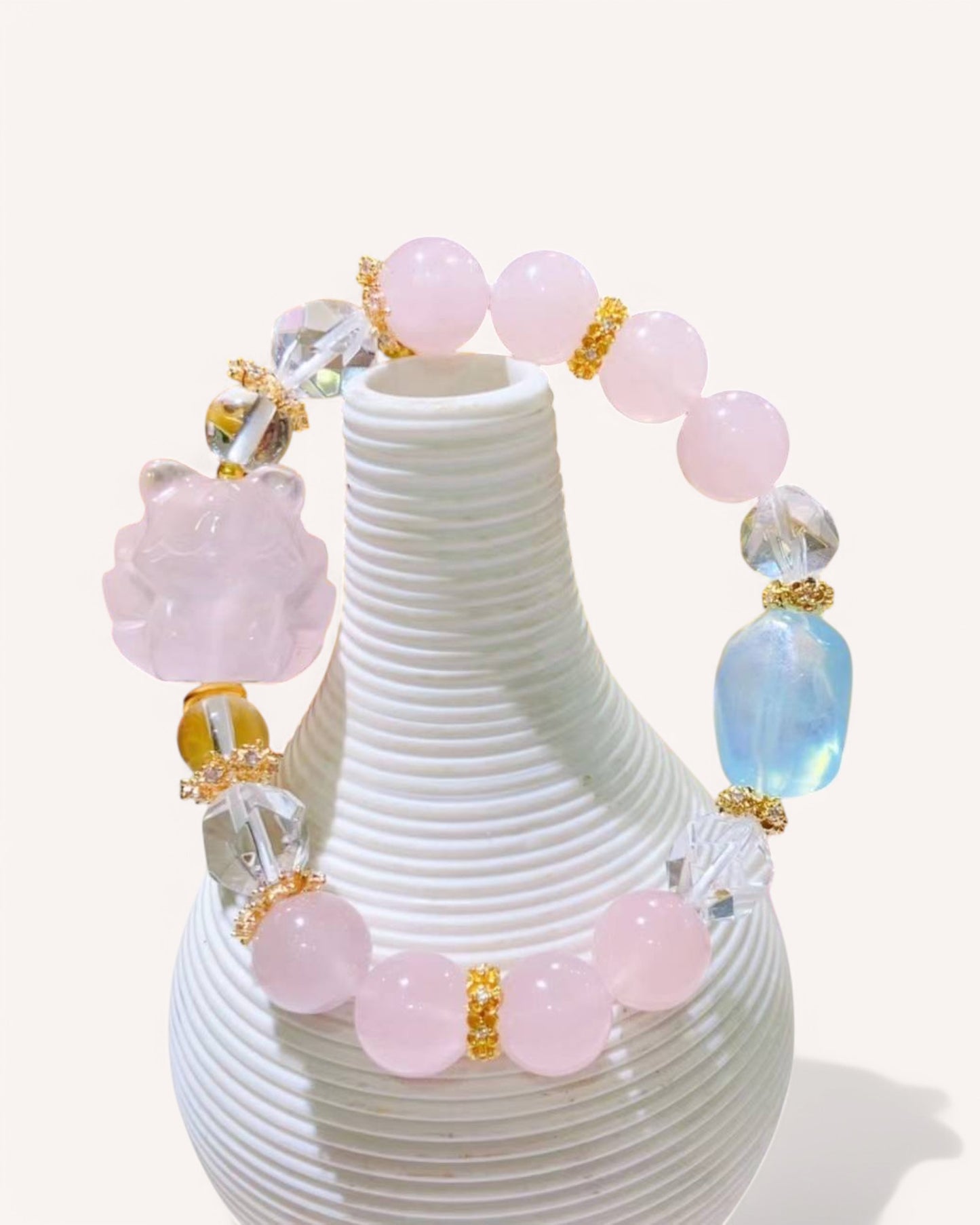 A stunning Love & Intuition Bracelet featuring Rose Quartz, White Quartz, and Aquamarine, adorned with a carved nine-tailed fox charm symbolizing love, attraction, and harmony.