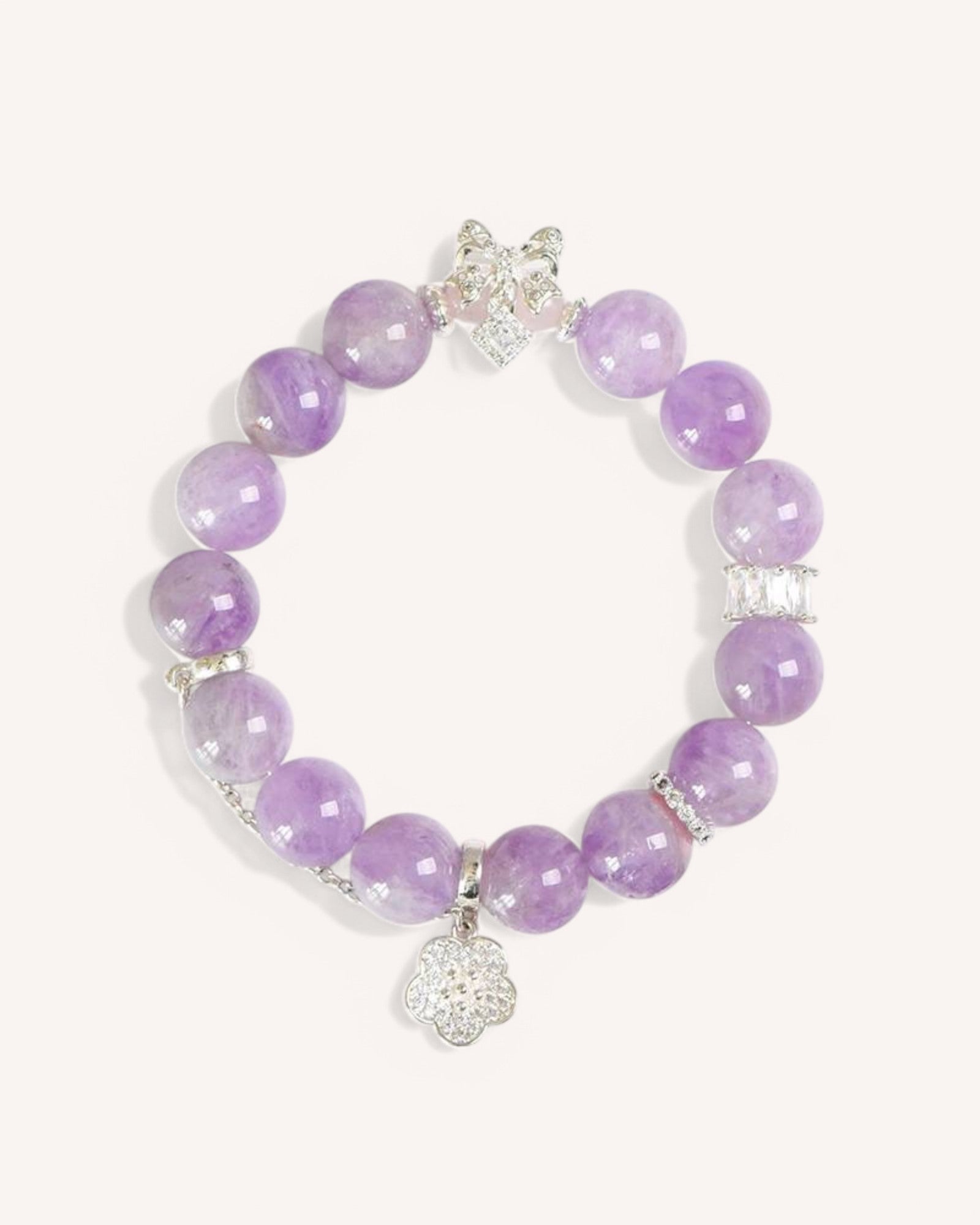 A beautifully arranged Lavender Amethyst Bracelet with a crystal charm, symbolizing harmony, self-discovery, and spiritual connection.