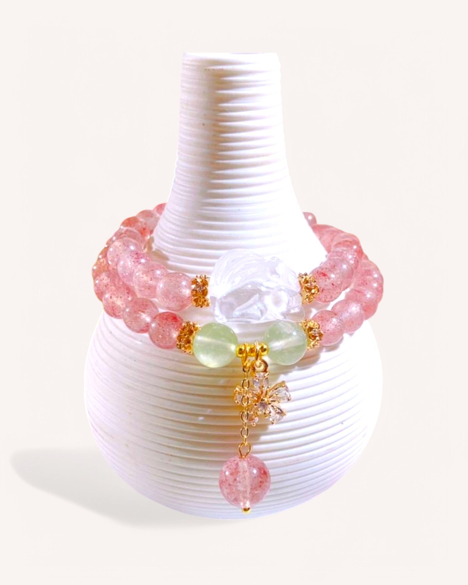 Elegant Strawberry Quartz bracelet with white Nine-Tailed Fox charm and Natural Grape Stone, displayed on a white ceramic holder to highlight love and healing energy.