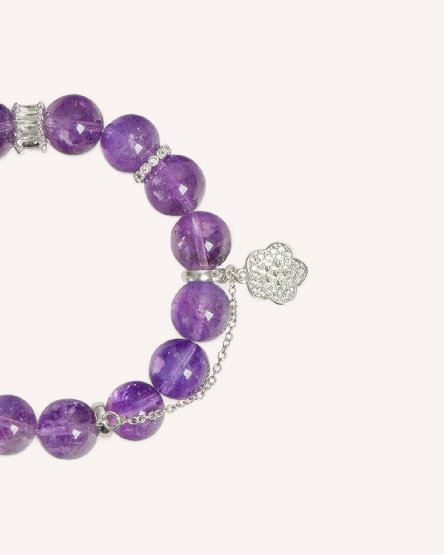 Close-up shot of the amethyst energy bracelet, highlighting its silver accents, lotus charm, and polished gemstone beads, crafted for meditation, relaxation, and positive vibrations.