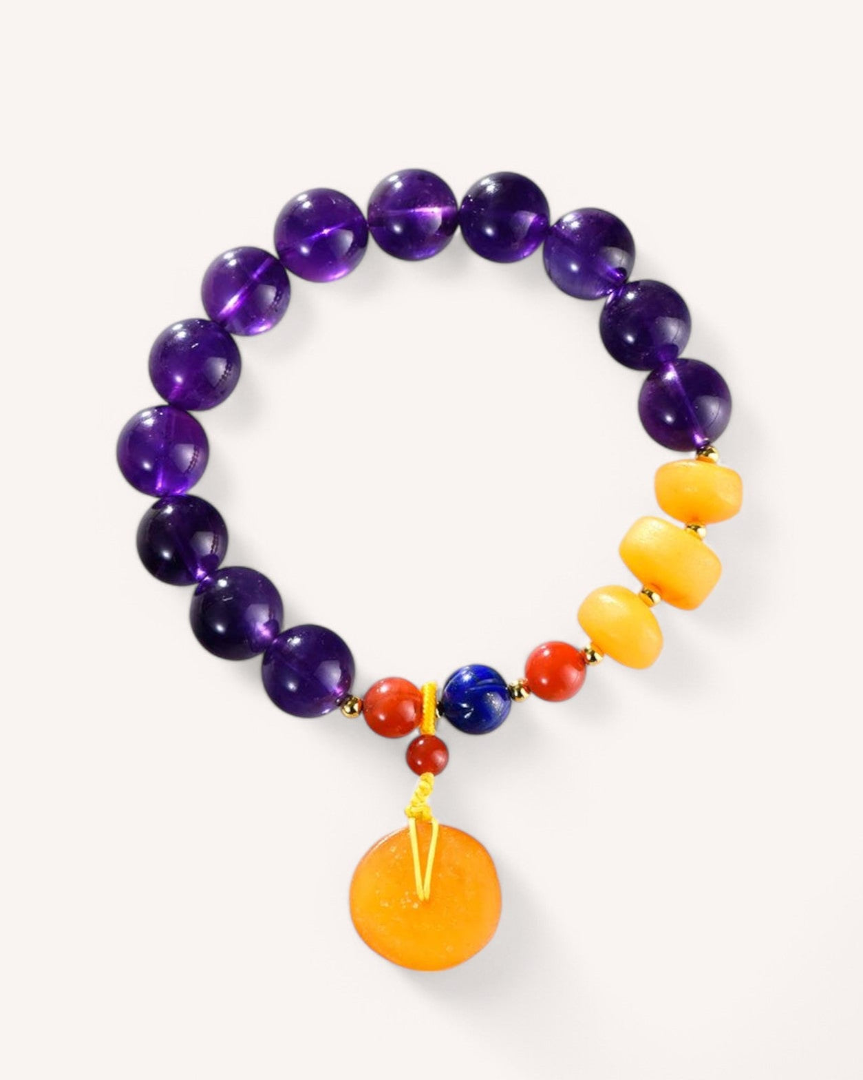 Amethyst and Honey Amber Energy Healing Bracelet featuring deep purple amethyst beads, golden honey amber, and red agate accents for vitality, protection, and emotional balance.