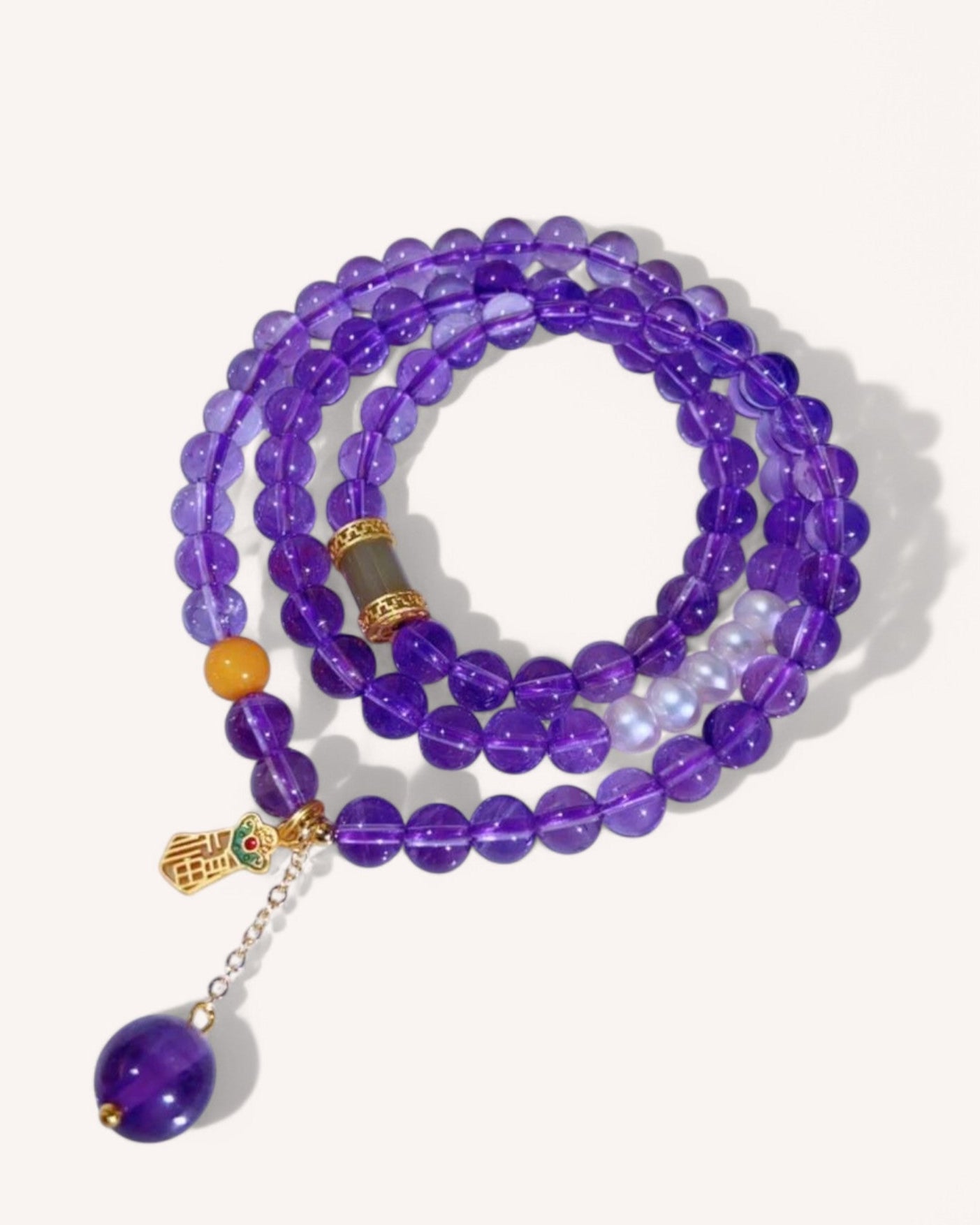 Close-up of the Amethyst & Honey Amber Prosperity Wrap Bracelet, featuring deep purple amethyst beads and golden honey amber for wealth, confidence, and energy healing.