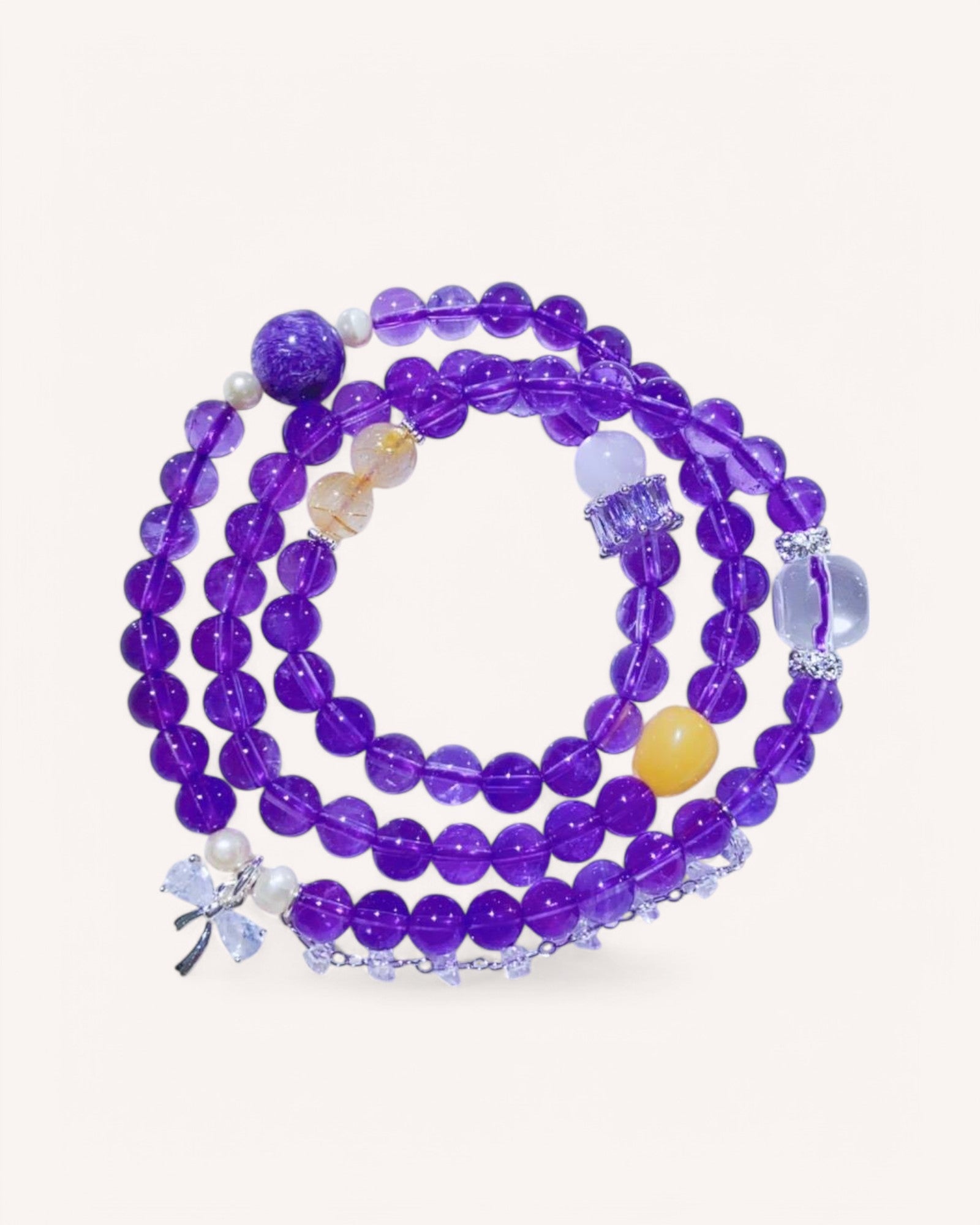 Triple-wrap amethyst and moonstone bracelet featuring honey amber and white quartz for intuition, spiritual clarity, and energy balance.