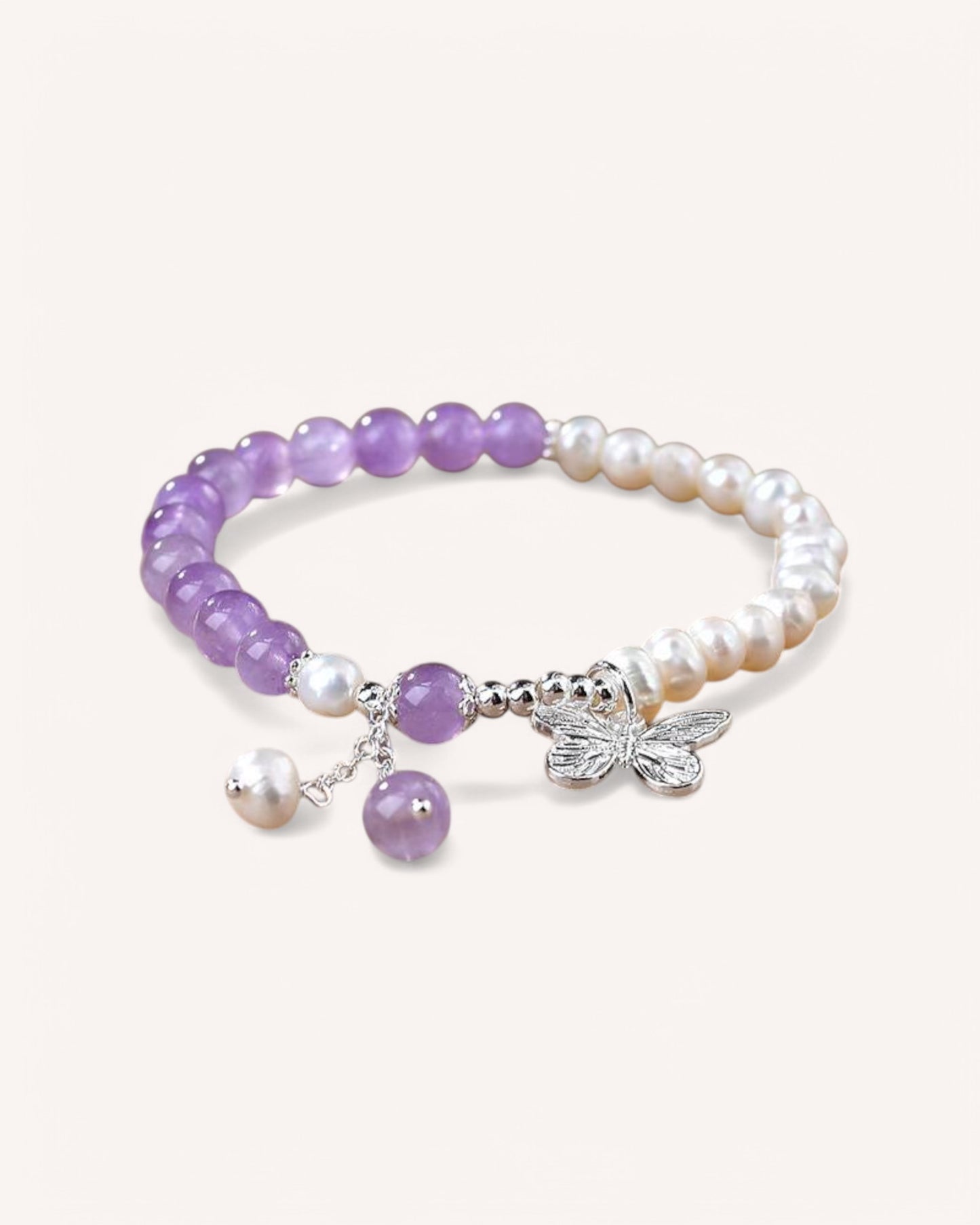 A stylish Amethyst & Pearl Bracelet worn on a woman's wrist, blending spiritual awareness with elegance. Perfect for enhancing intuition, wisdom, and feminine energy.