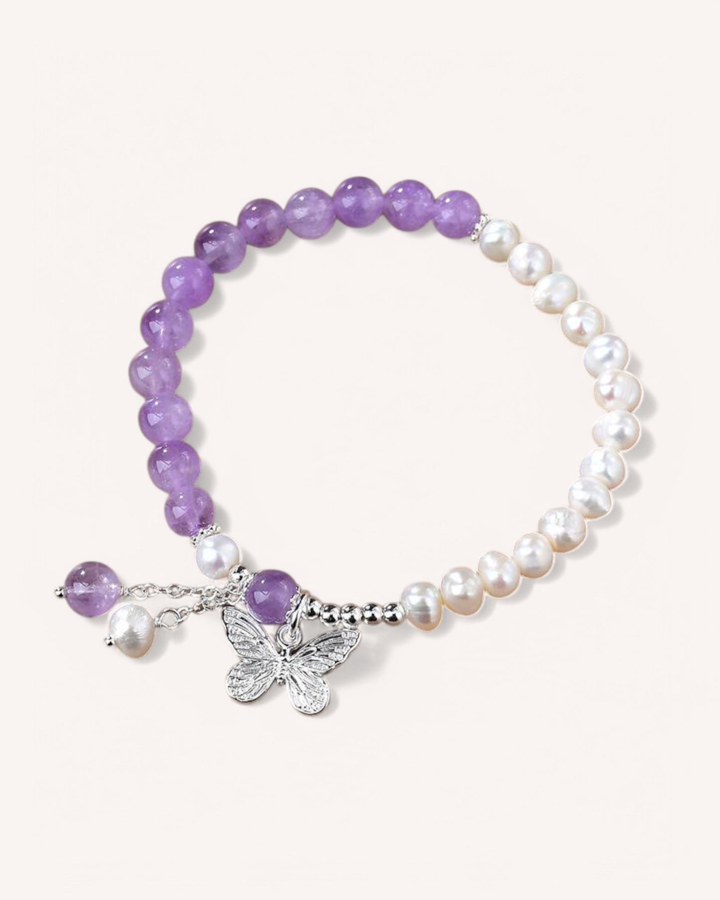 Elegant Amethyst & Pearl Butterfly Bracelet, symbolizing transformation, wisdom, and feminine energy. Featuring natural amethyst, pearls, and a delicate butterfly charm for spiritual growth and balance.