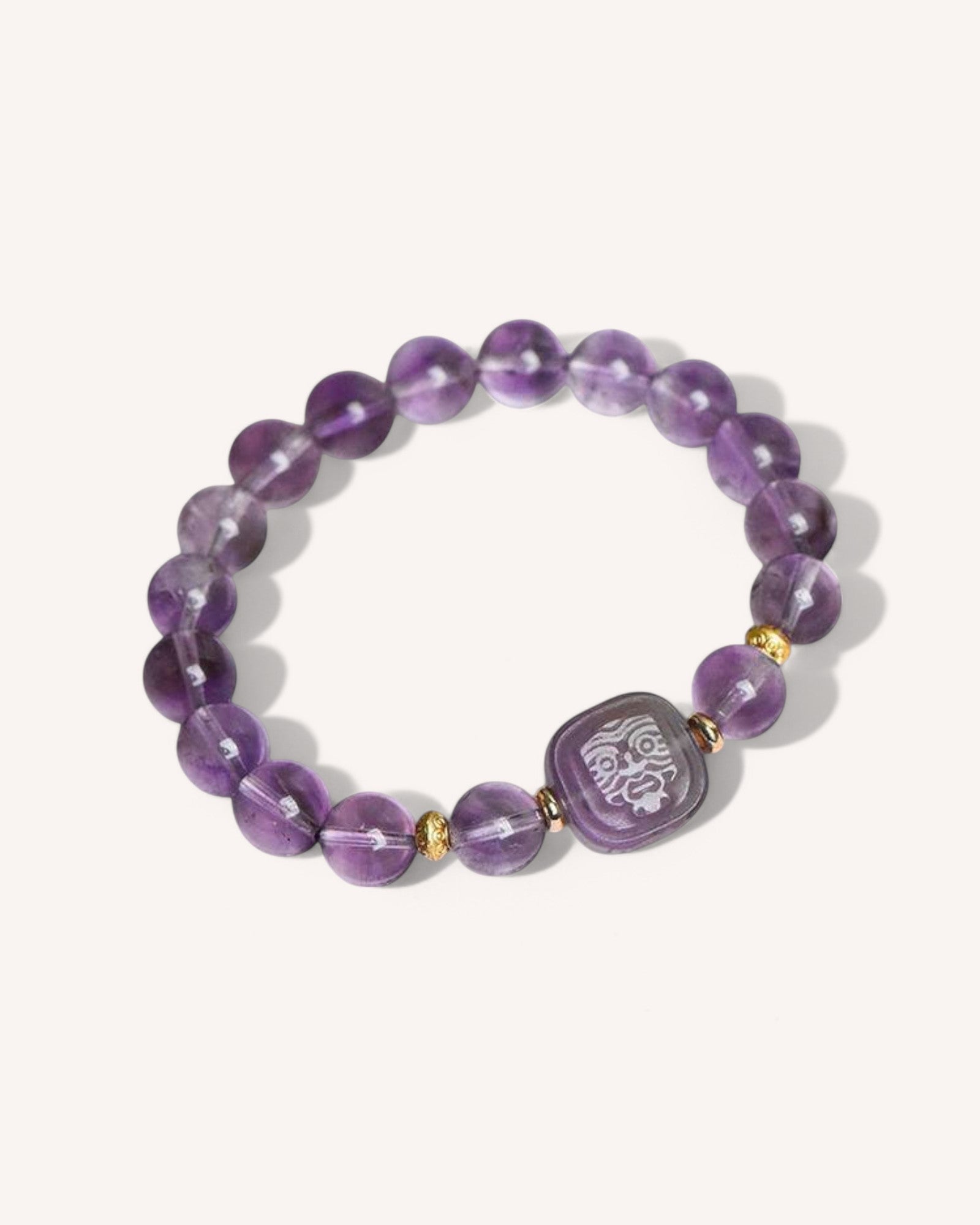 Close-up of Amethyst Spiritual Protection Bracelet featuring natural amethyst beads and an engraved charm, designed for wisdom, stress relief, and emotional balance.