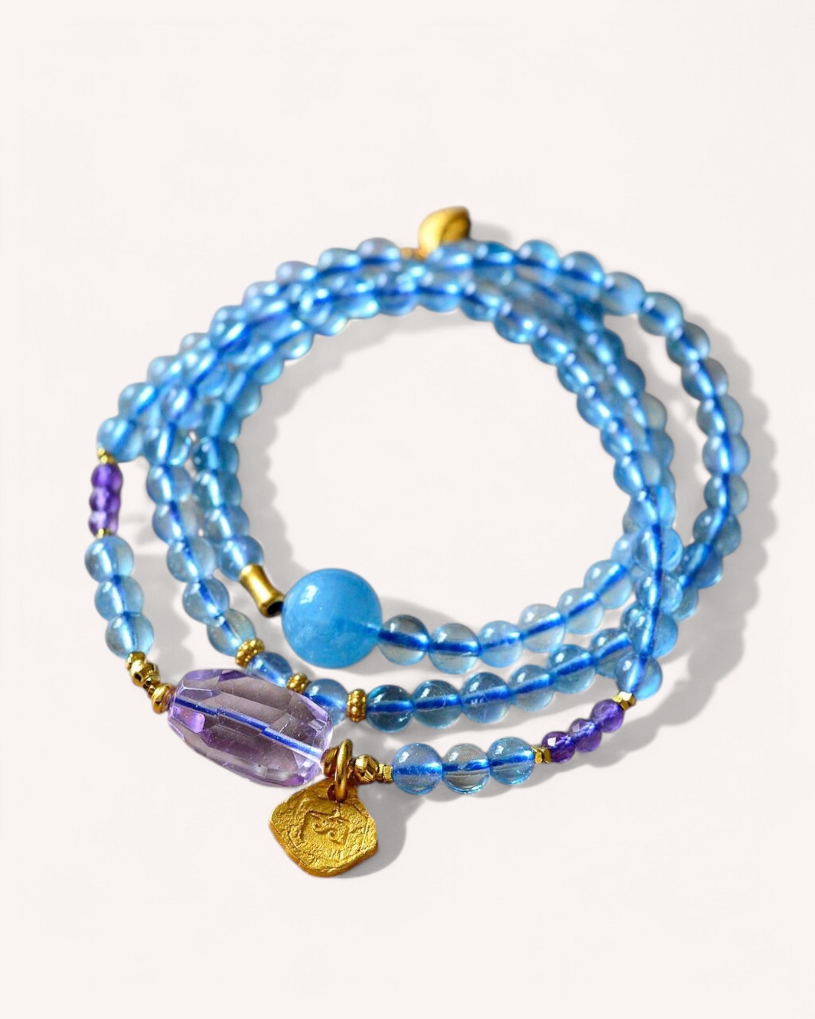 Healing crystal wrap bracelet with aquamarine and amethyst beads, promoting calmness and spiritual clarity