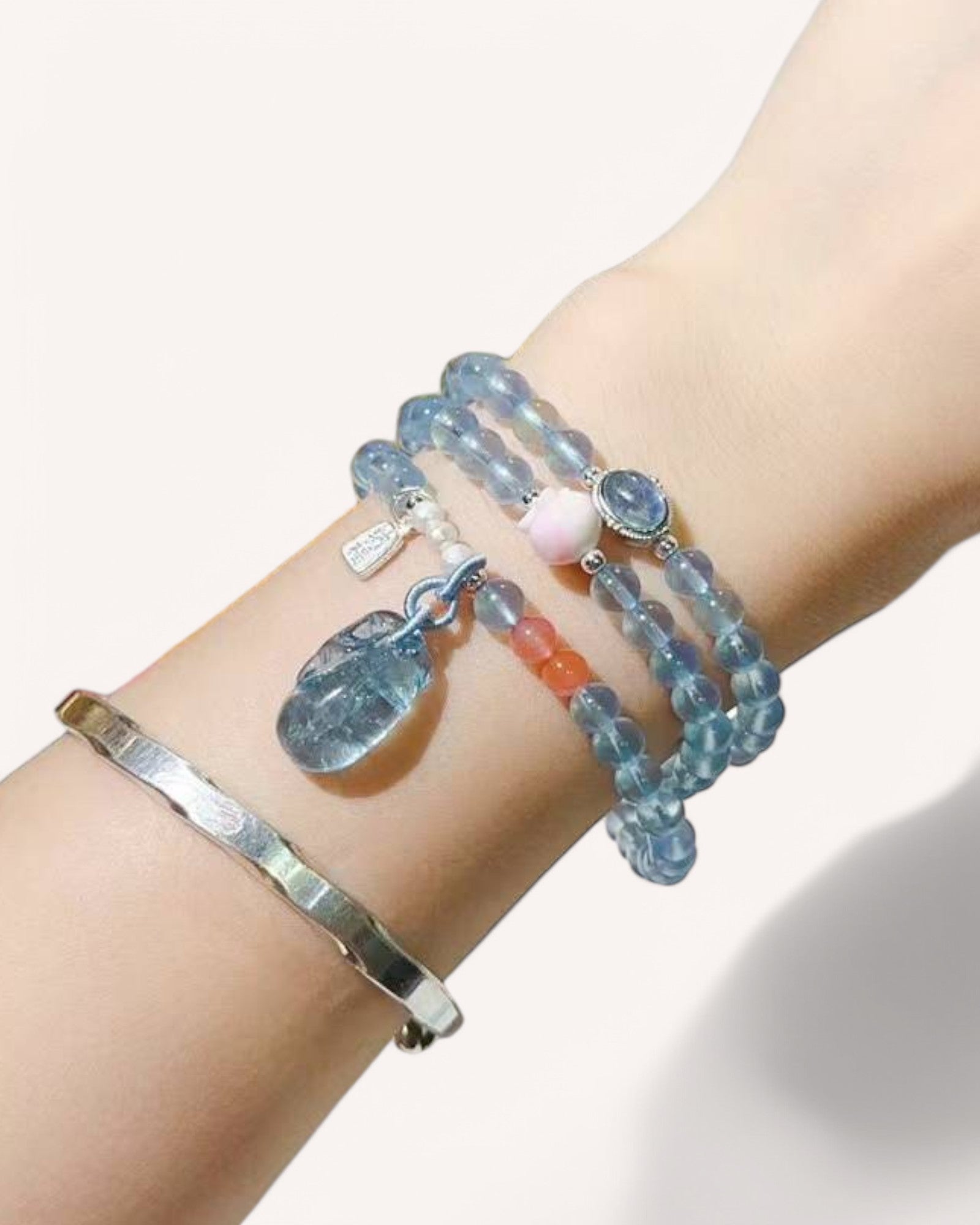 Aquamarine mala bracelet worn on wrist, wrapped style for tranquility and meditation.
