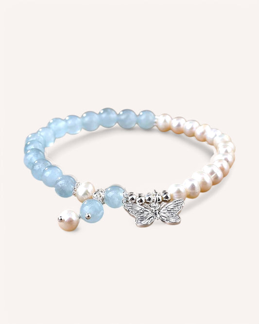Side view of Aquamarine and Pearl bracelet featuring delicate silver butterfly charm