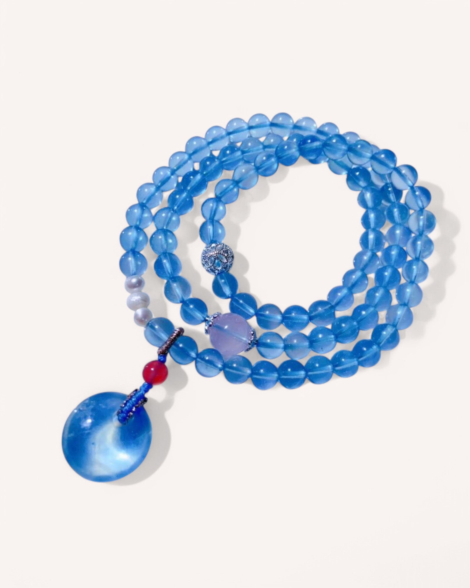 Triple-layer healing bracelet made of Aquamarine, Rose Quartz, and Pearl, designed for love, self-compassion, and emotional balance.