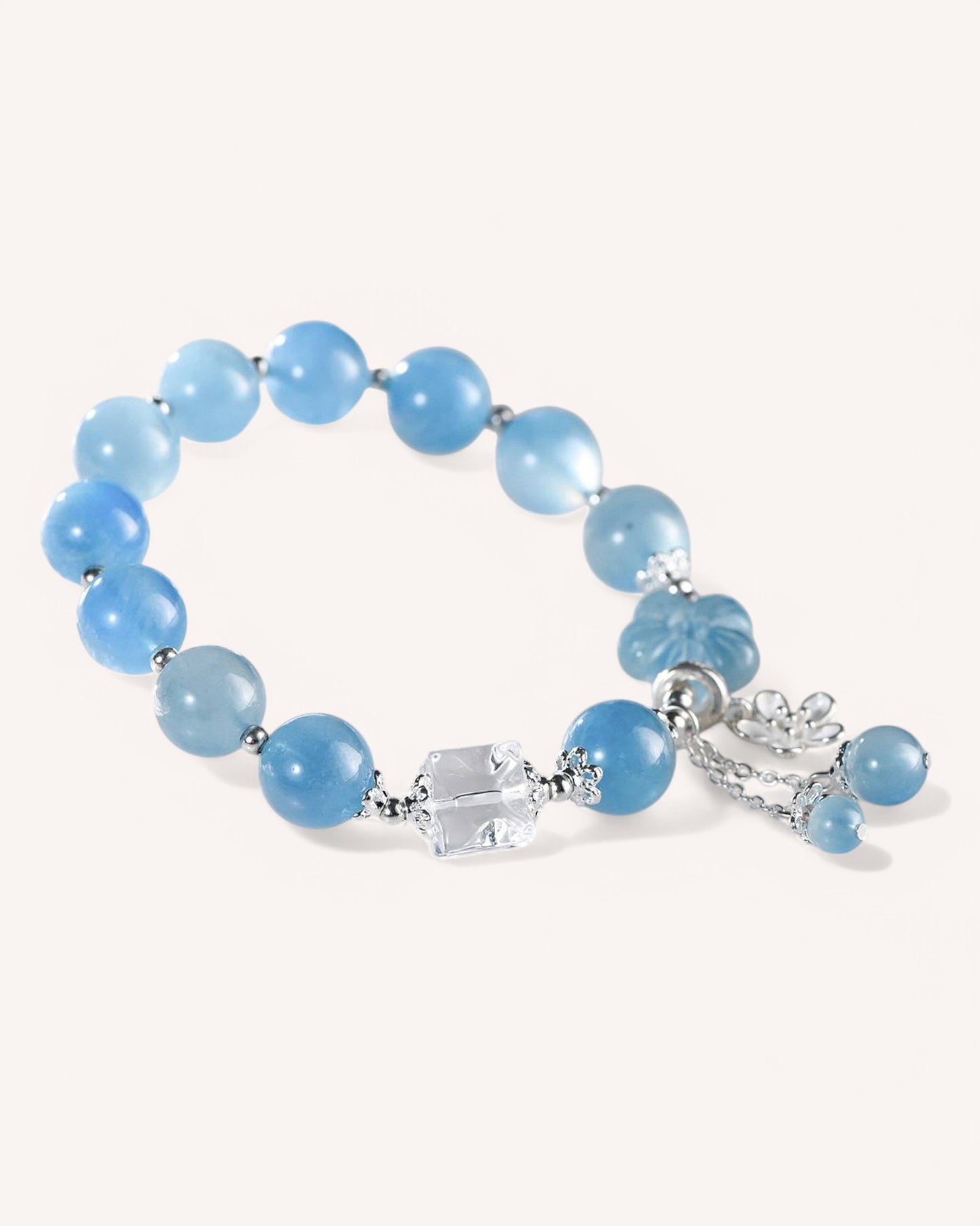 Side angle of calming Aquamarine and White Quartz crystal bracelet featuring silver accent and charm for stress relief and clarity.