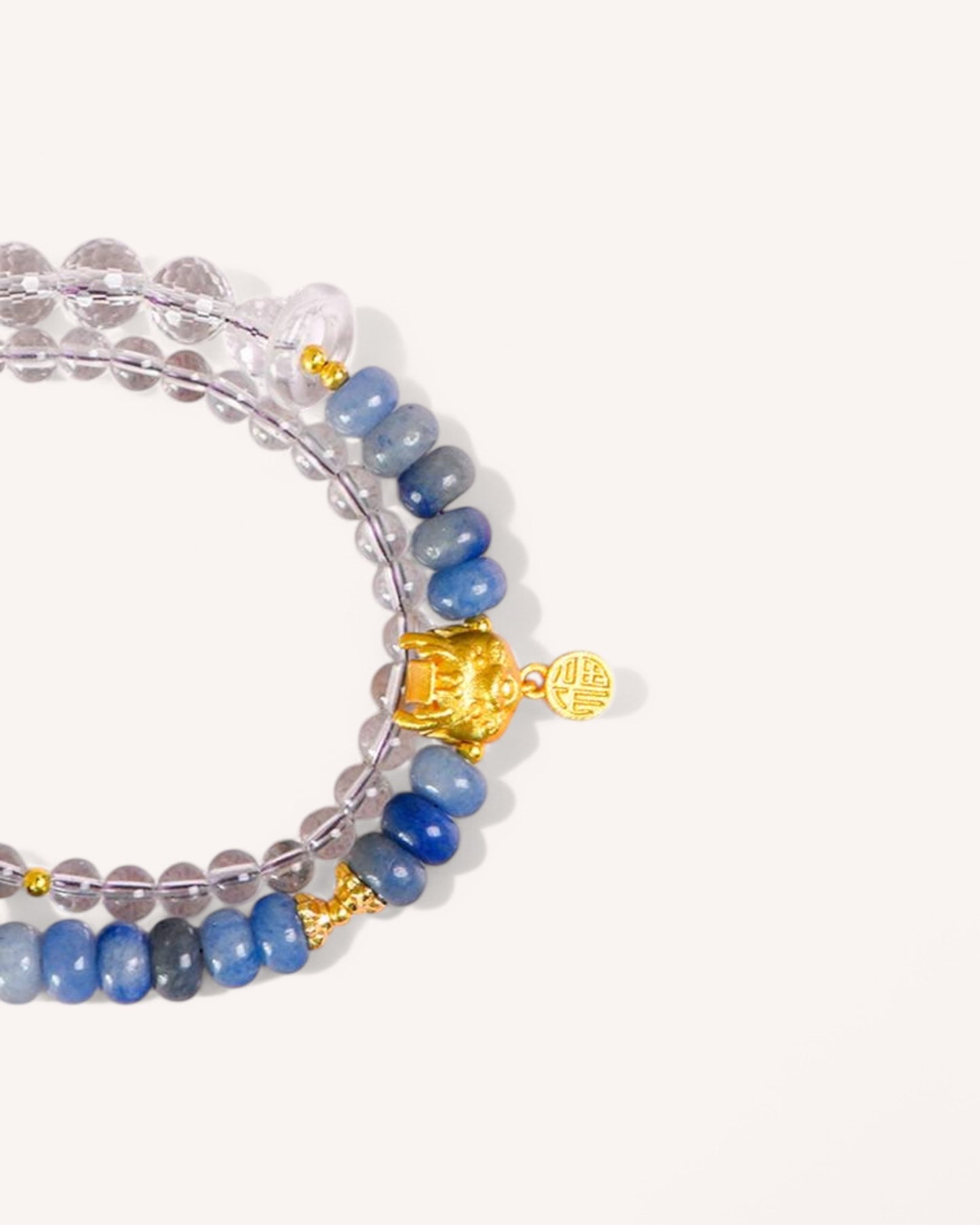 ide-angle shot of the Blue Aventurine & White Quartz Bracelet, showcasing its elegant gold accents and layered bead design for stress relief and intuition enhancement.