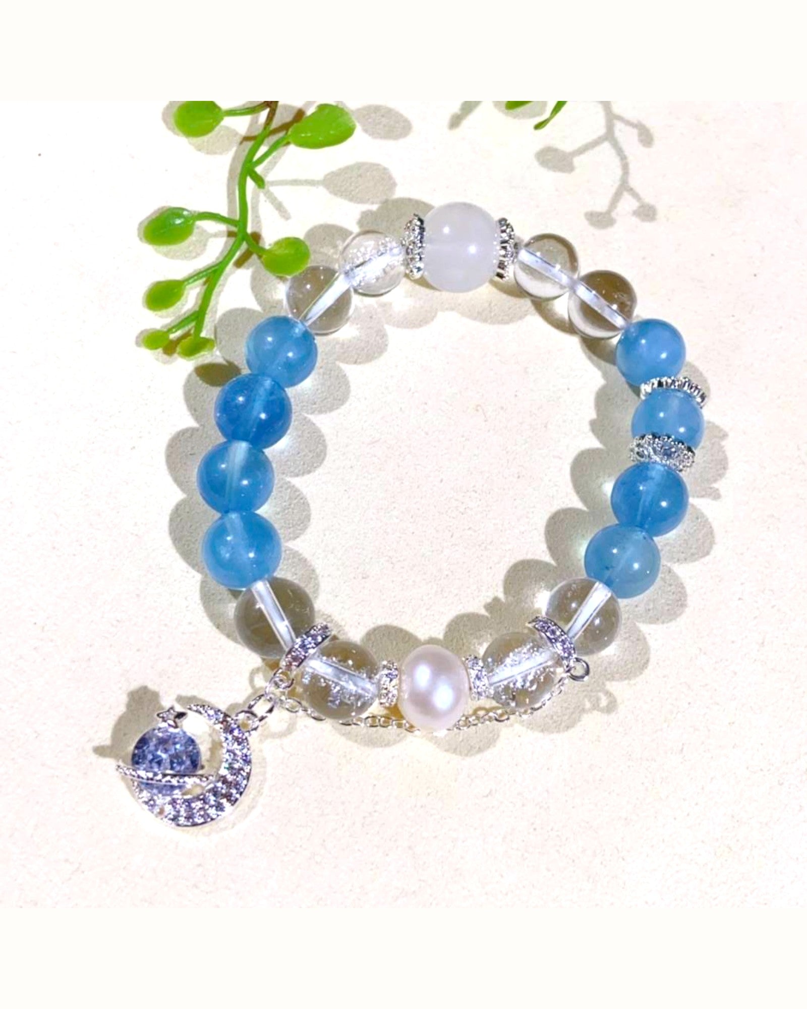 Close-up of the Celestial Harmony Aquamarine & White Quartz Bracelet, featuring aquamarine beads, white quartz, pearl, and a blue moonstone charm for intuition, peace, and emotional clarity.