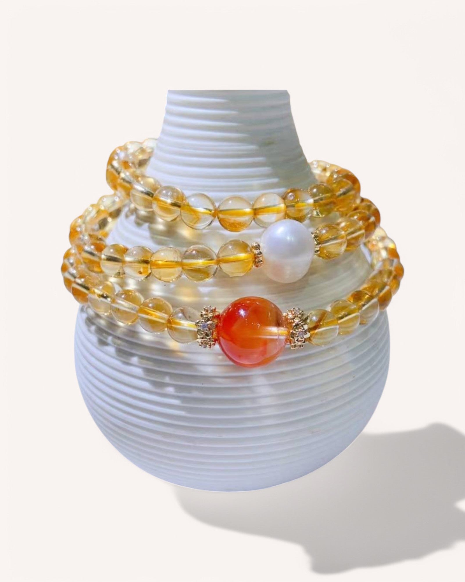 Citrine & Rutilated Quartz Energy Bracelet – A powerful multi-layer healing bracelet infused with abundance, emotional strength, and clarity. Showcased with Pearl and Red Rabbit Hair Quartz for love and self-empowerment.
