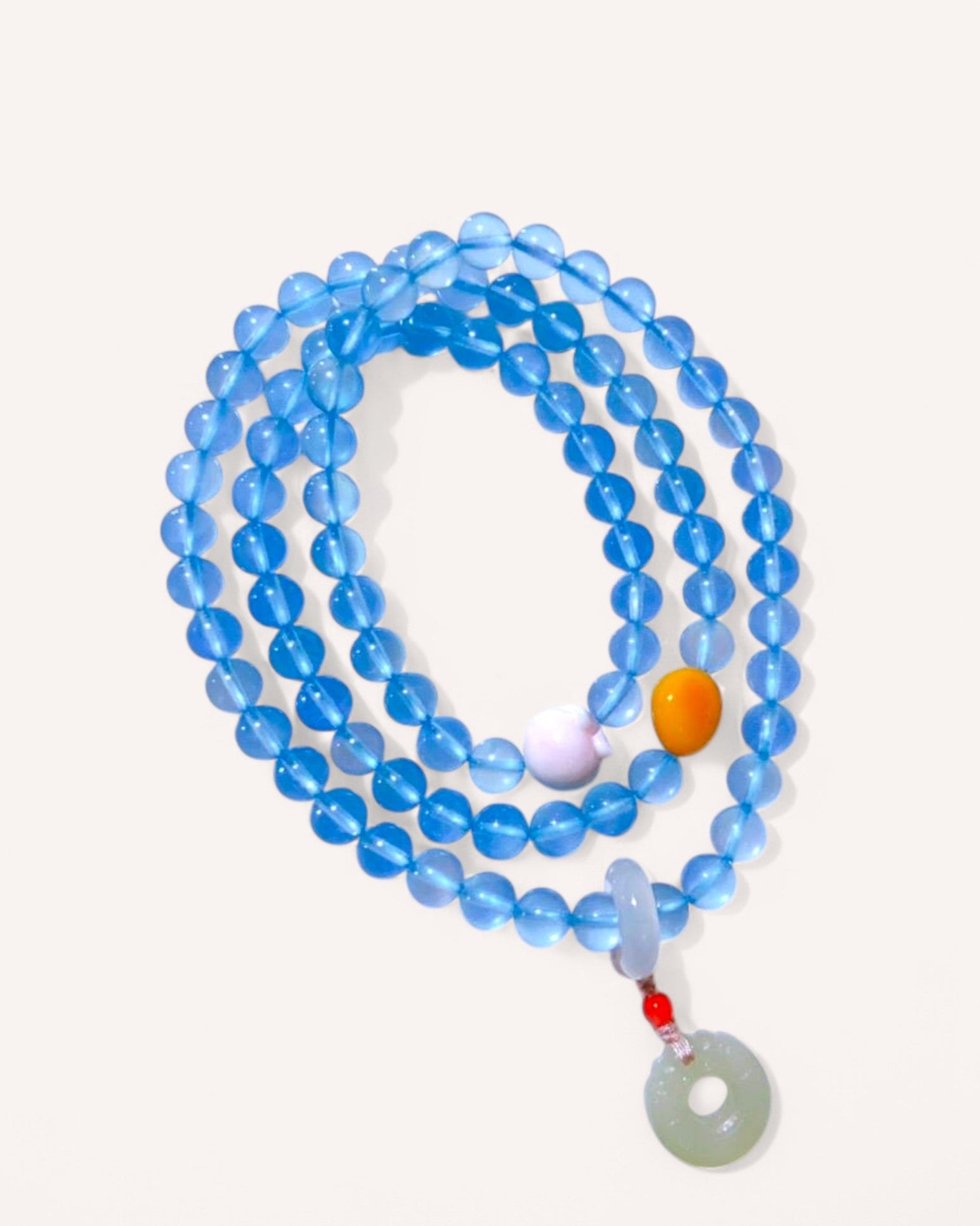 Triple-layer healing bracelet made of aquamarine, amber, and Hetian jade for emotional balance and inner peace.