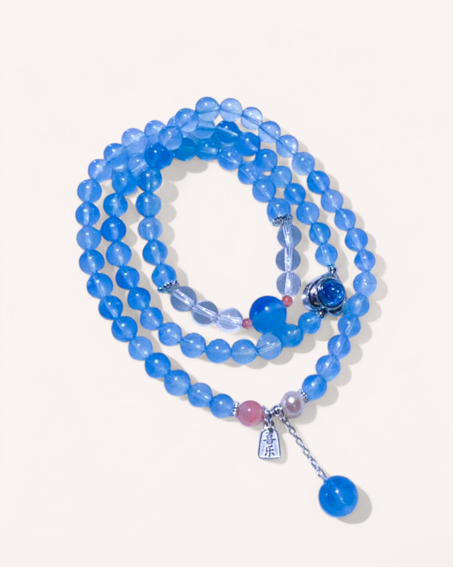 Multilayer healing crystal bracelet featuring aquamarine and white quartz for emotional balance and clarity, shown laid flat.