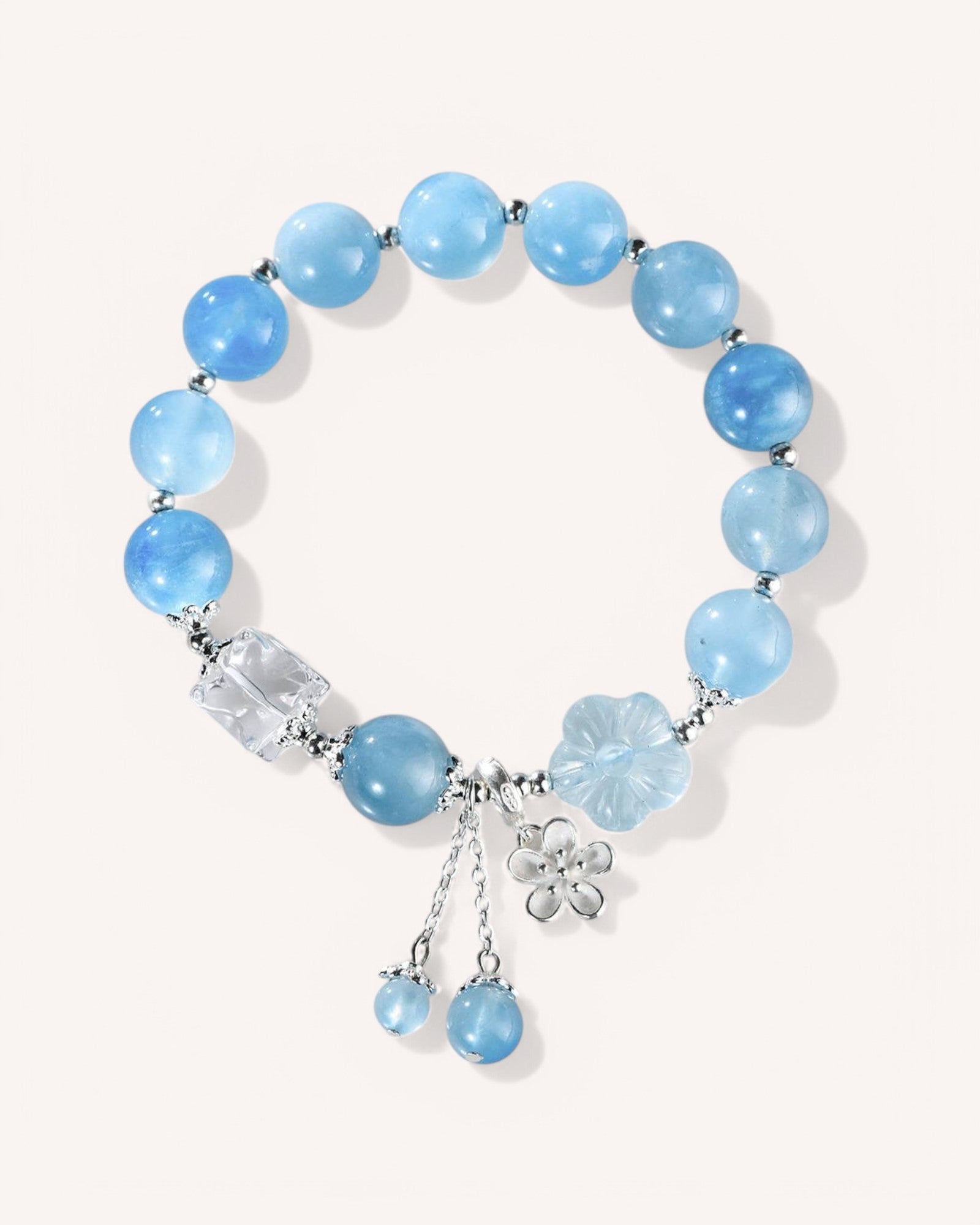 Front view of Aquamarine and White Quartz healing bracelet with silver charms, designed for emotional clarity and energy cleansing.