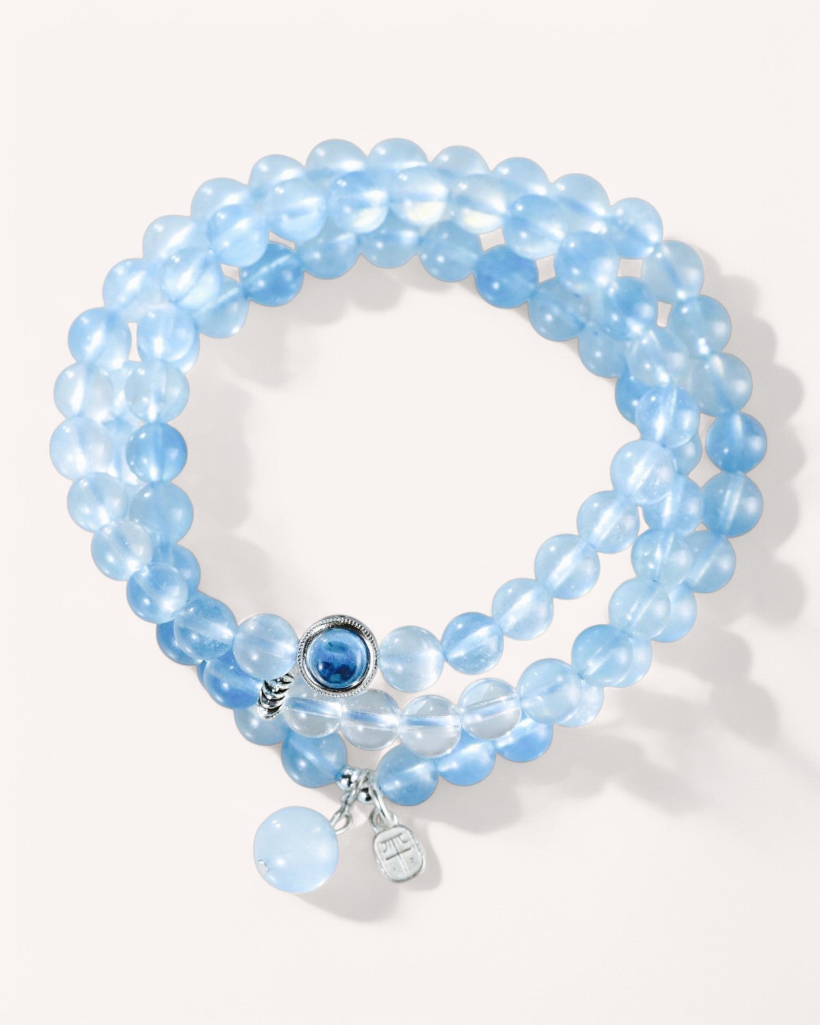 Front view of emotional healing aquamarine multi-layer bracelet with silver charm for peace and clarity
