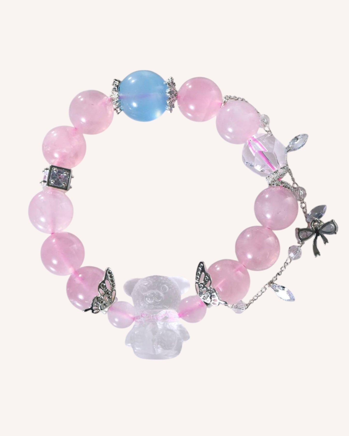 Front view of emotional healing rose quartz and aquamarine crystal bracelet with white quartz and silver flower charm for balance and love.