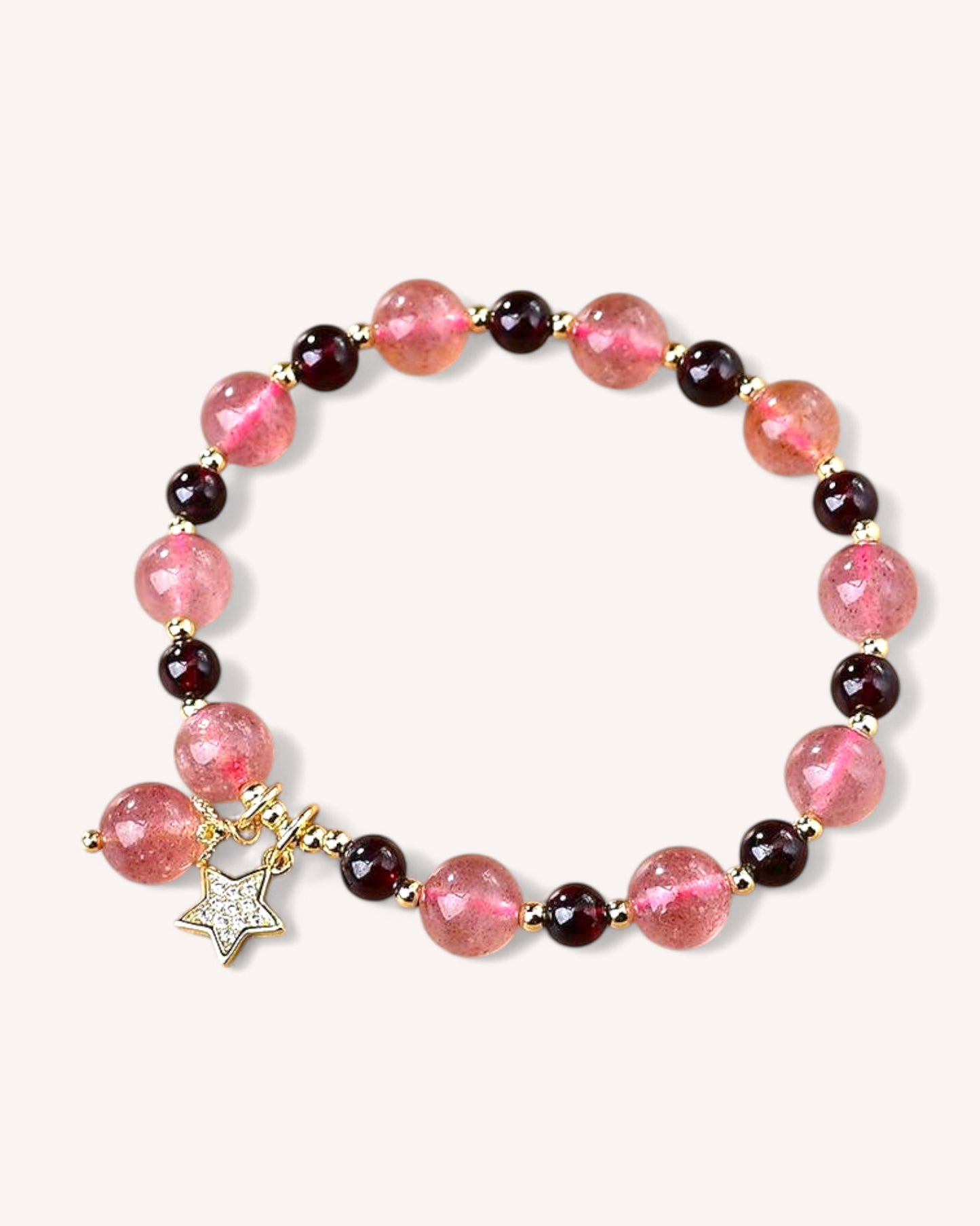Close-up of Strawberry Quartz & Garnet bracelet featuring gold alloy star charm, enhancing love and vitality