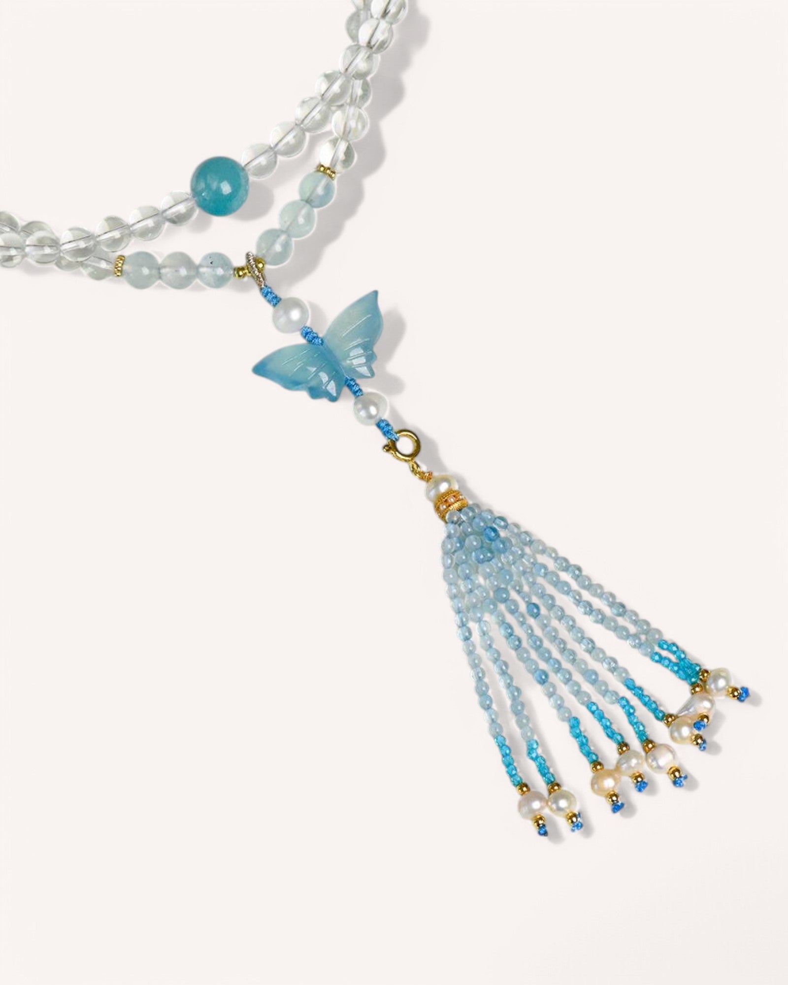 Healing White Quartz & Aquamarine Butterfly Bracelet with tassel detail, symbolizing transformation, intuition, and inner peace.