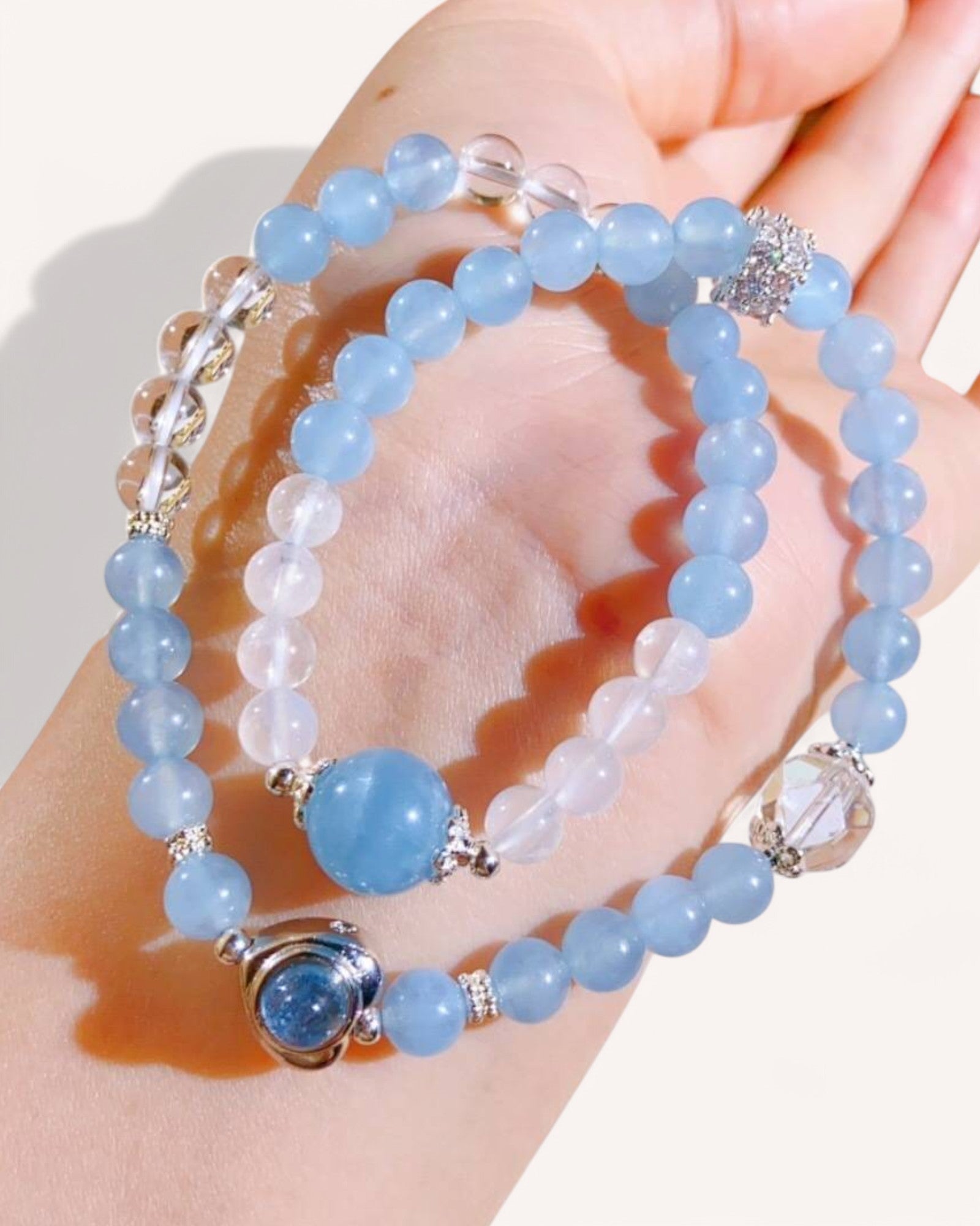 Model wearing aquamarine and blue moonstone double-layer bracelet for intuition and emotional healing