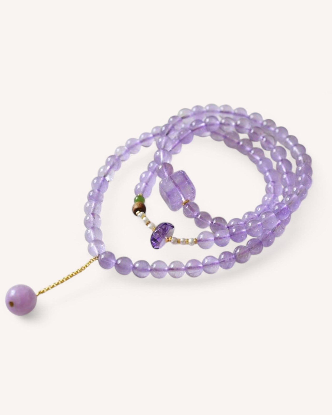 Lavender Amethyst Mala Bracelet for spiritual protection and emotional healing, featuring a triple-wrap design with gold accents for elegance and tranquility.