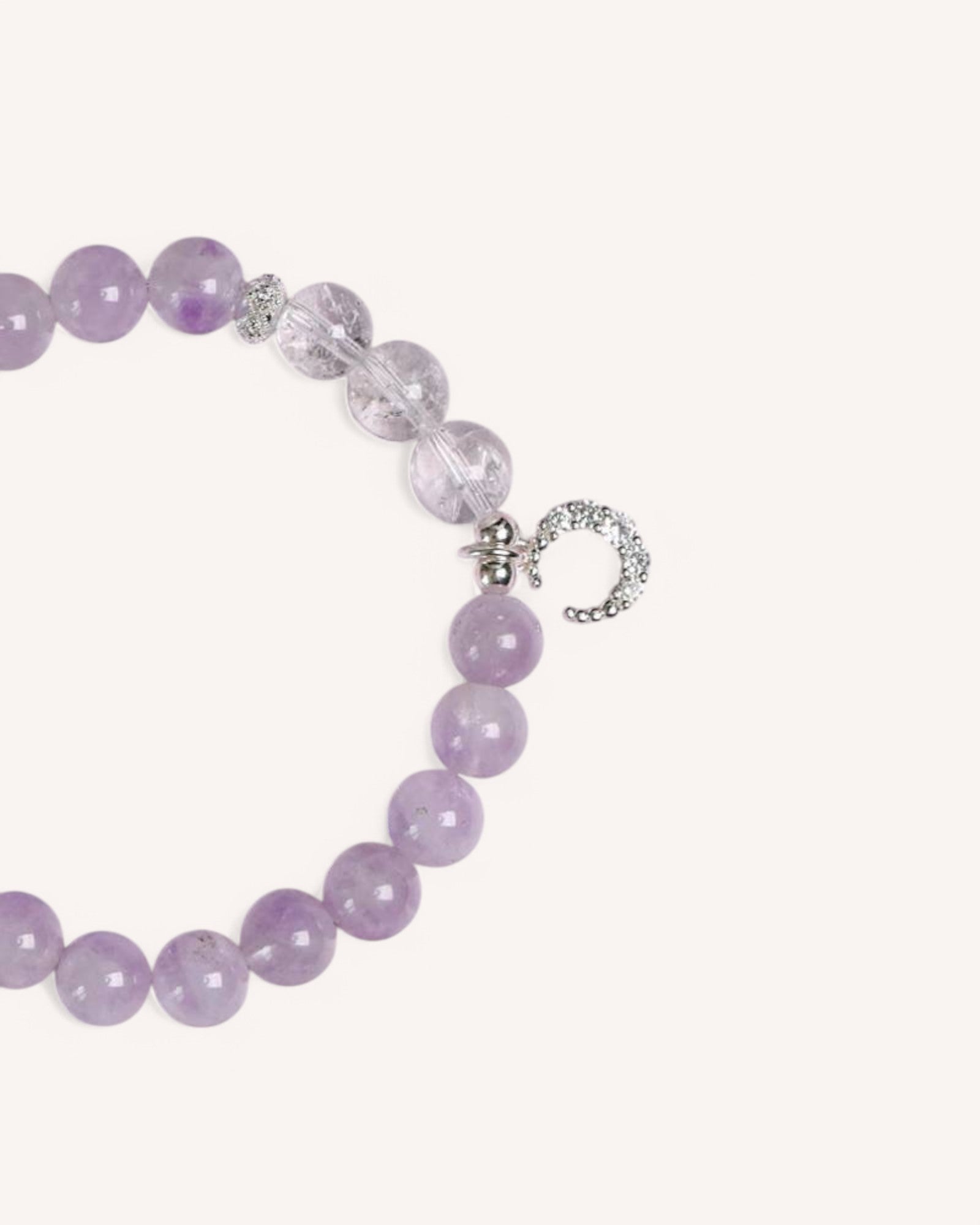 Side view of the Lavender Amethyst & White Quartz Bracelet, designed for emotional balance, spiritual clarity, and energy alignment, with a silver moon charm symbolizing renewal and peace.