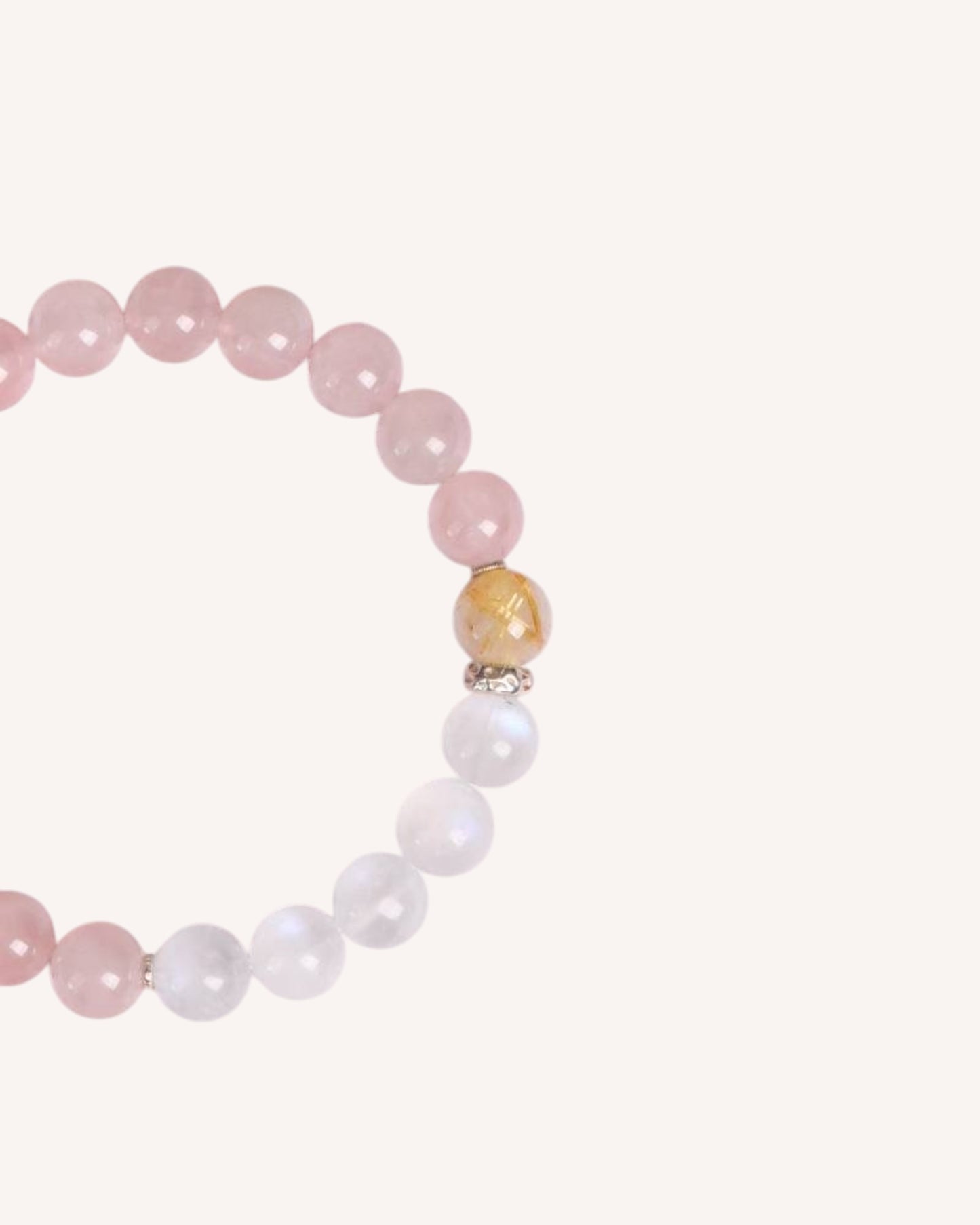 Close-up of the Love & Intuition Rose Quartz & Blue Moonstone Bracelet, highlighting the Golden Rutilated Quartz bead for abundance and success.