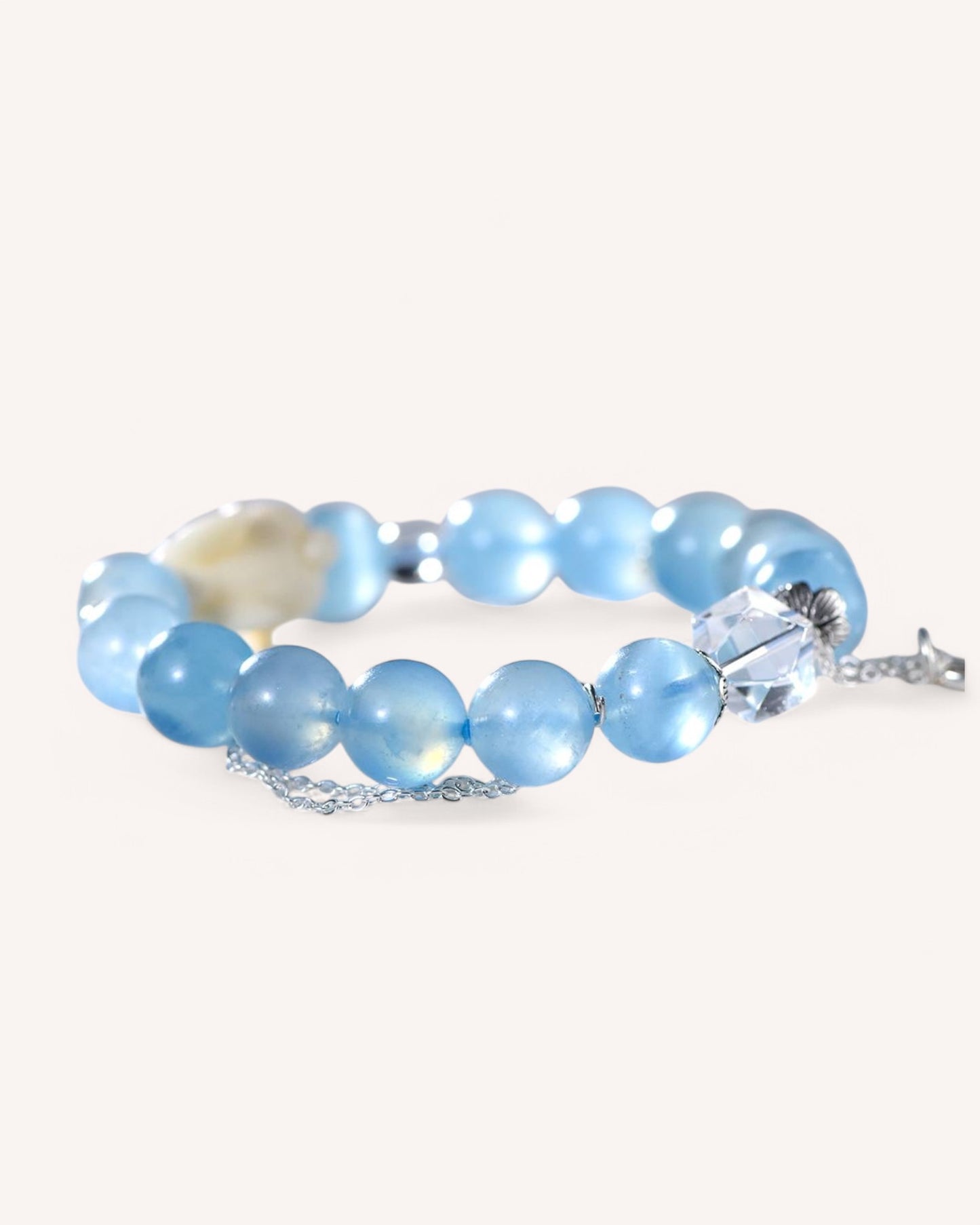 Aquamarine and white quartz crystal bracelet featuring ivory rabbit charm for emotional healing and positivity.