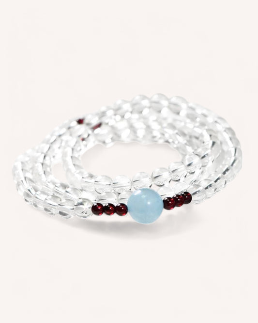 Elegant Aquamarine & White Quartz bracelet with Garnet accents, designed for confidence, stress relief, and positivity.