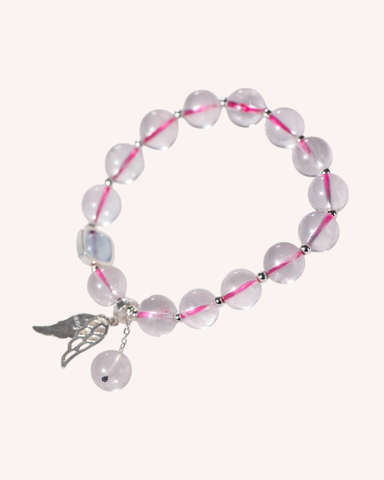 Rose Quartz and Aquamarine crystal bracelet with silver angel charm, promoting emotional balance, inner peace, and divine connection.