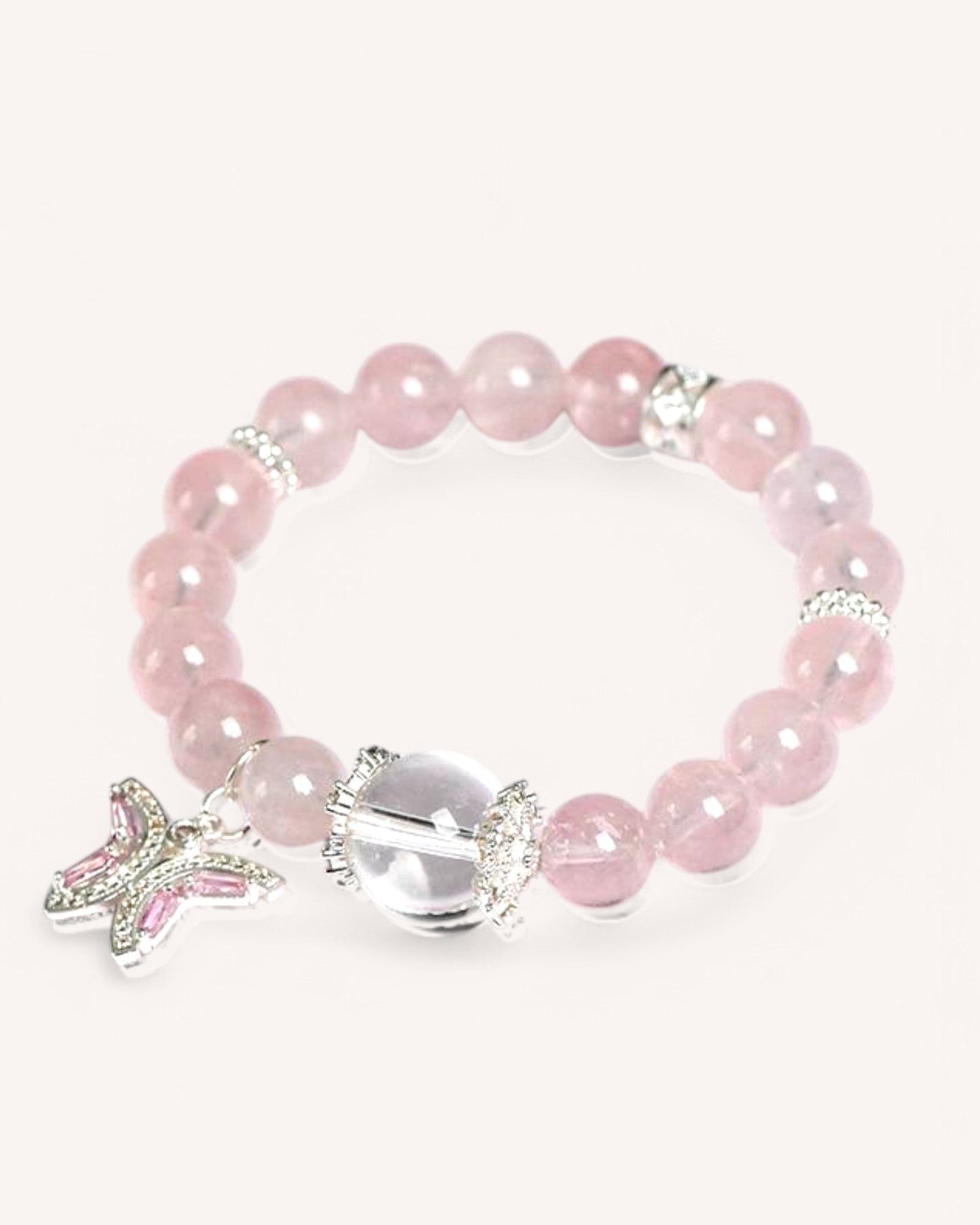 Close-up of the Butterfly Serenity Rose Quartz bracelet featuring a silver butterfly charm and White Quartz for emotional healing and balance.