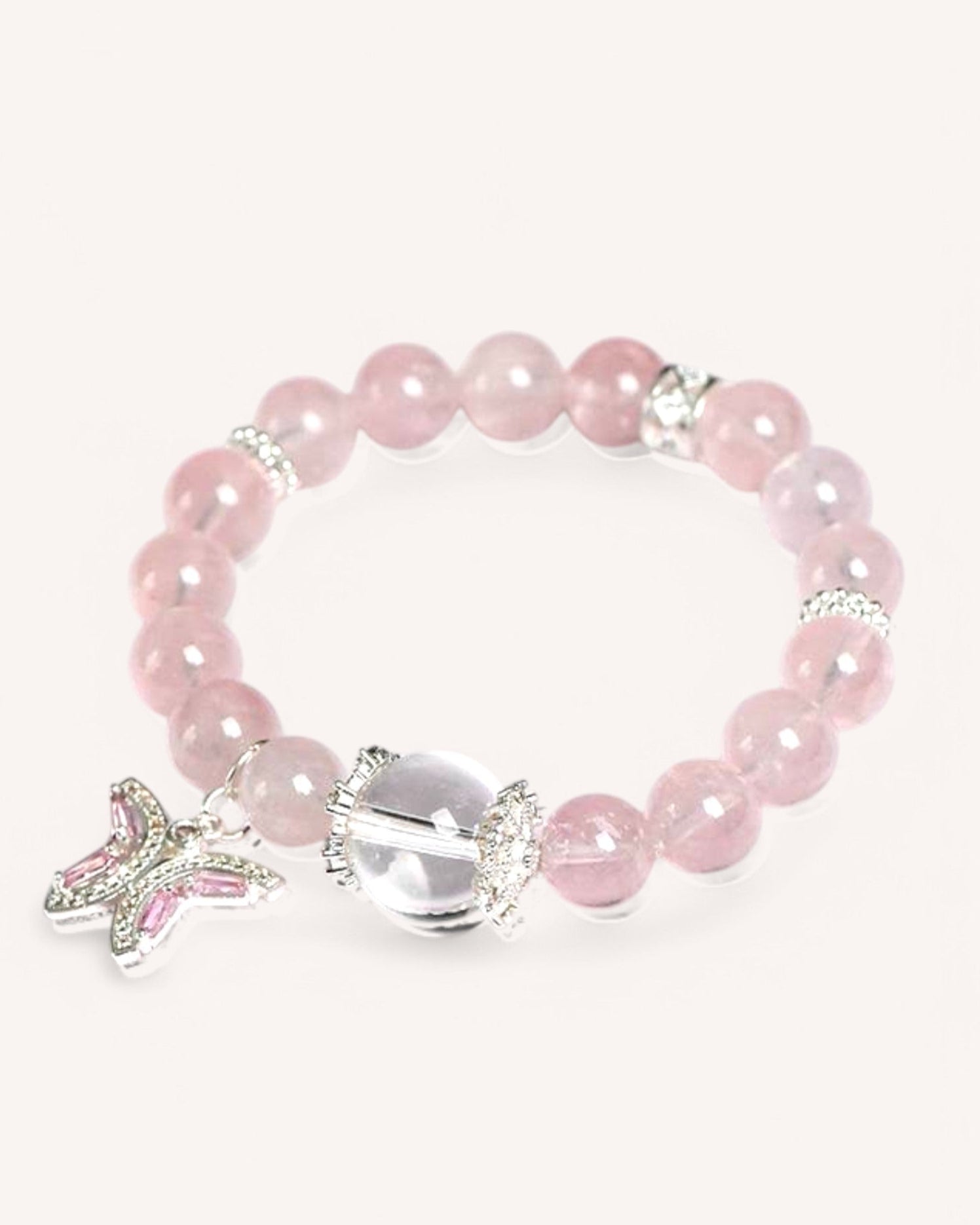 Close-up of the Butterfly Serenity Rose Quartz bracelet featuring a silver butterfly charm and White Quartz for emotional healing and balance.