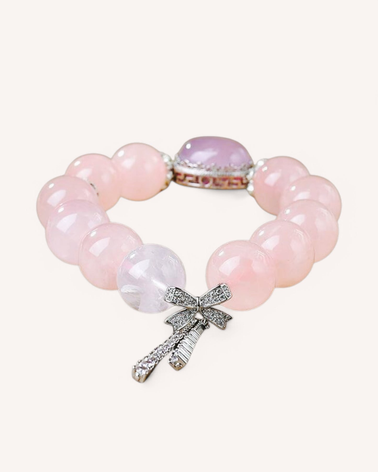 Rose quartz crystal bracelet with heart charm, promoting love, self-care, and emotional balance with a soft pink gemstone design.