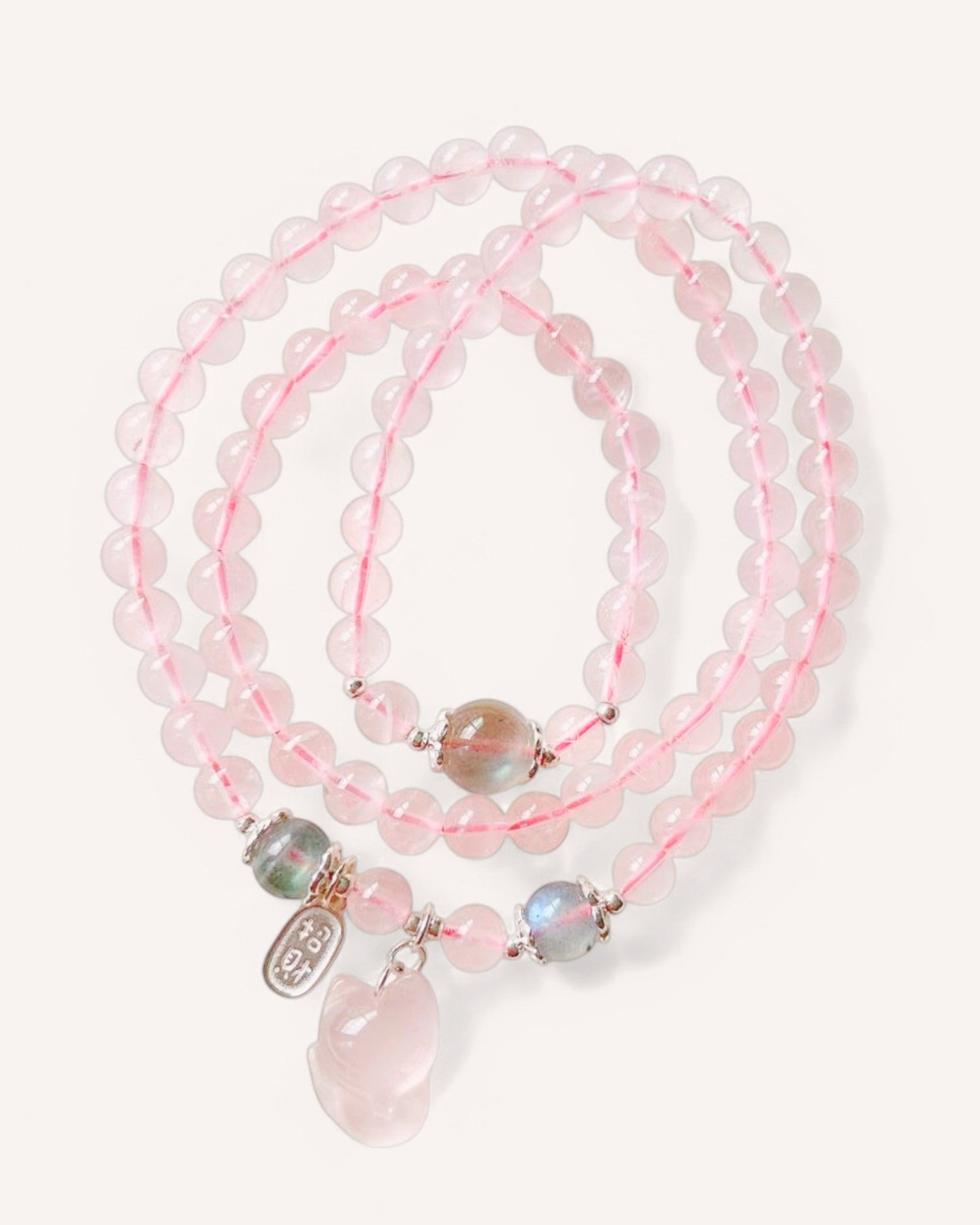 Flat lay of Rose Quartz & Moonstone multi-layer healing bracelet for emotional balance and spiritual growth